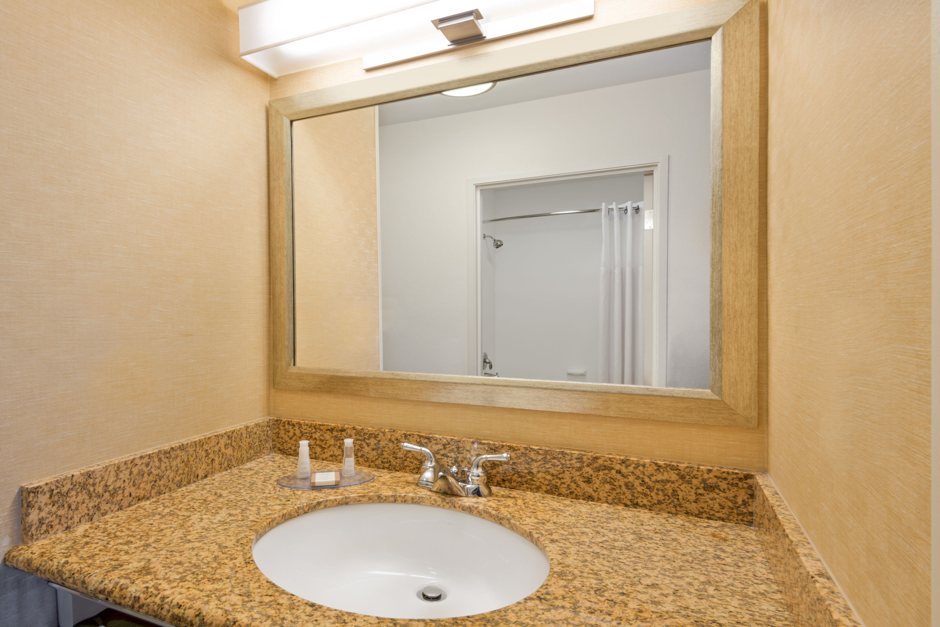 Guest room bath at the Baymont by Wyndham Denver International Airport in Denver, Colorado