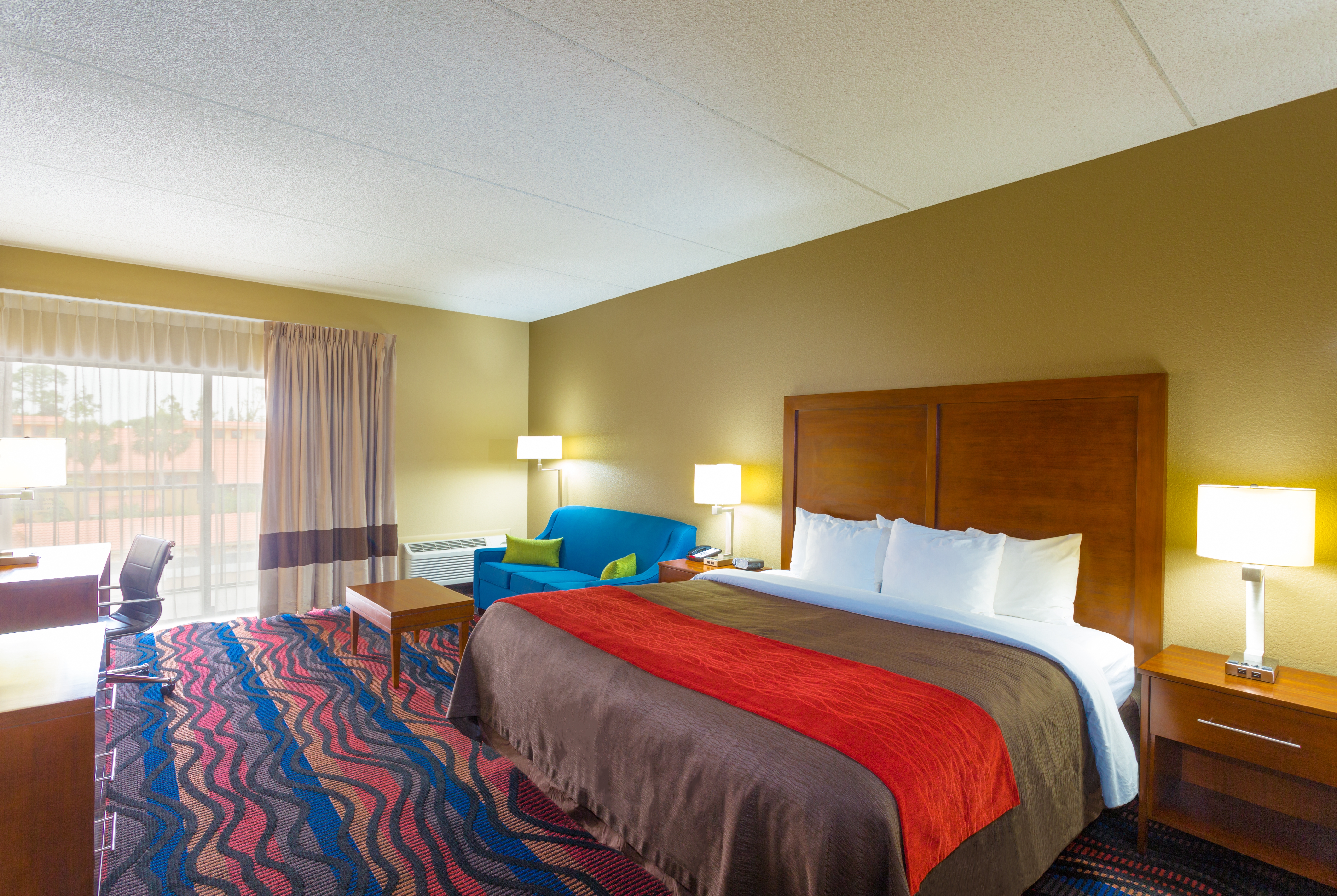 King bed guest room at the Baymont by Wyndham Bonita Springs Naples North in Bonita Springs, Florida