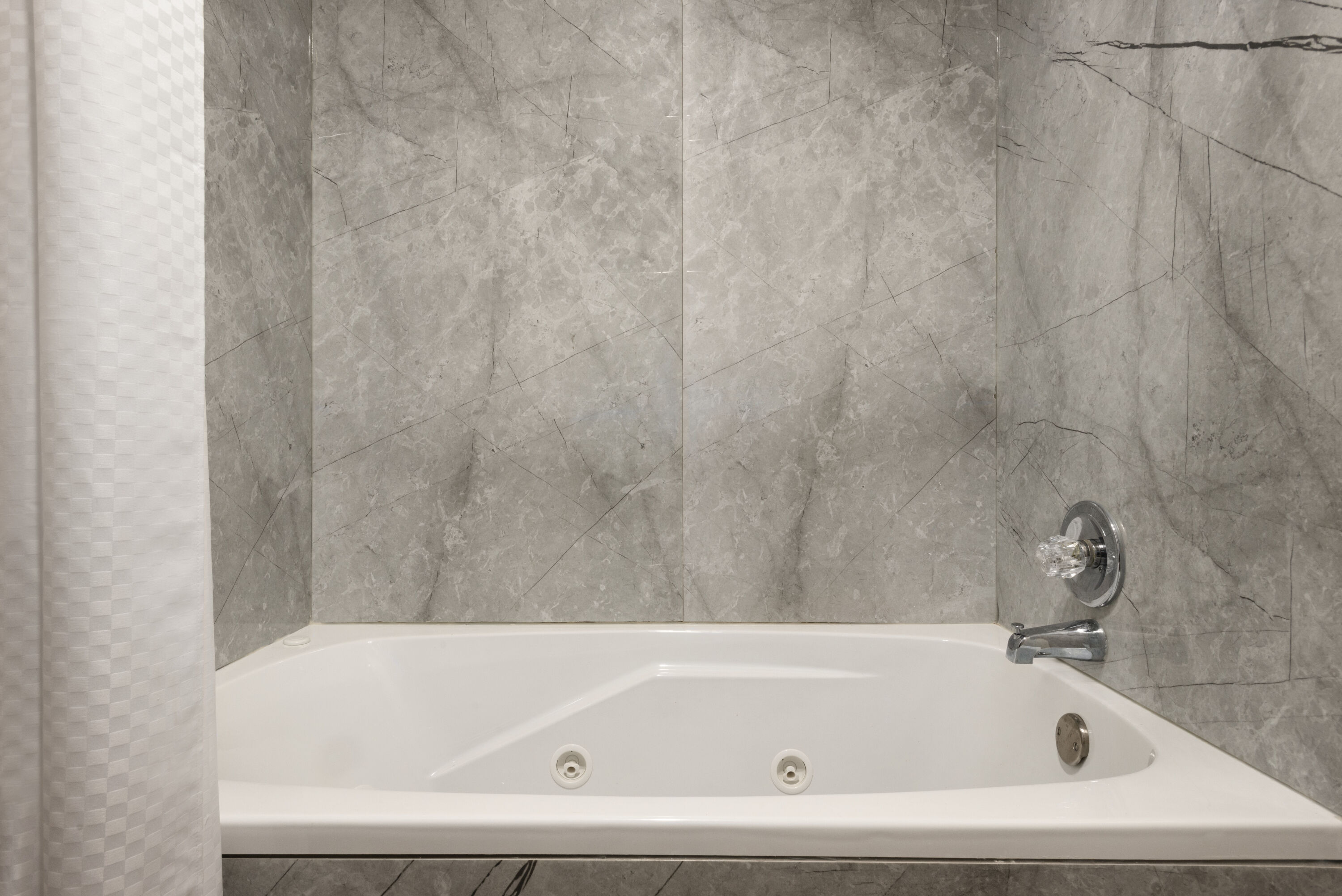 Guest room bath at the Baymont by Wyndham Muncie Near Ball State University in Muncie, Indiana