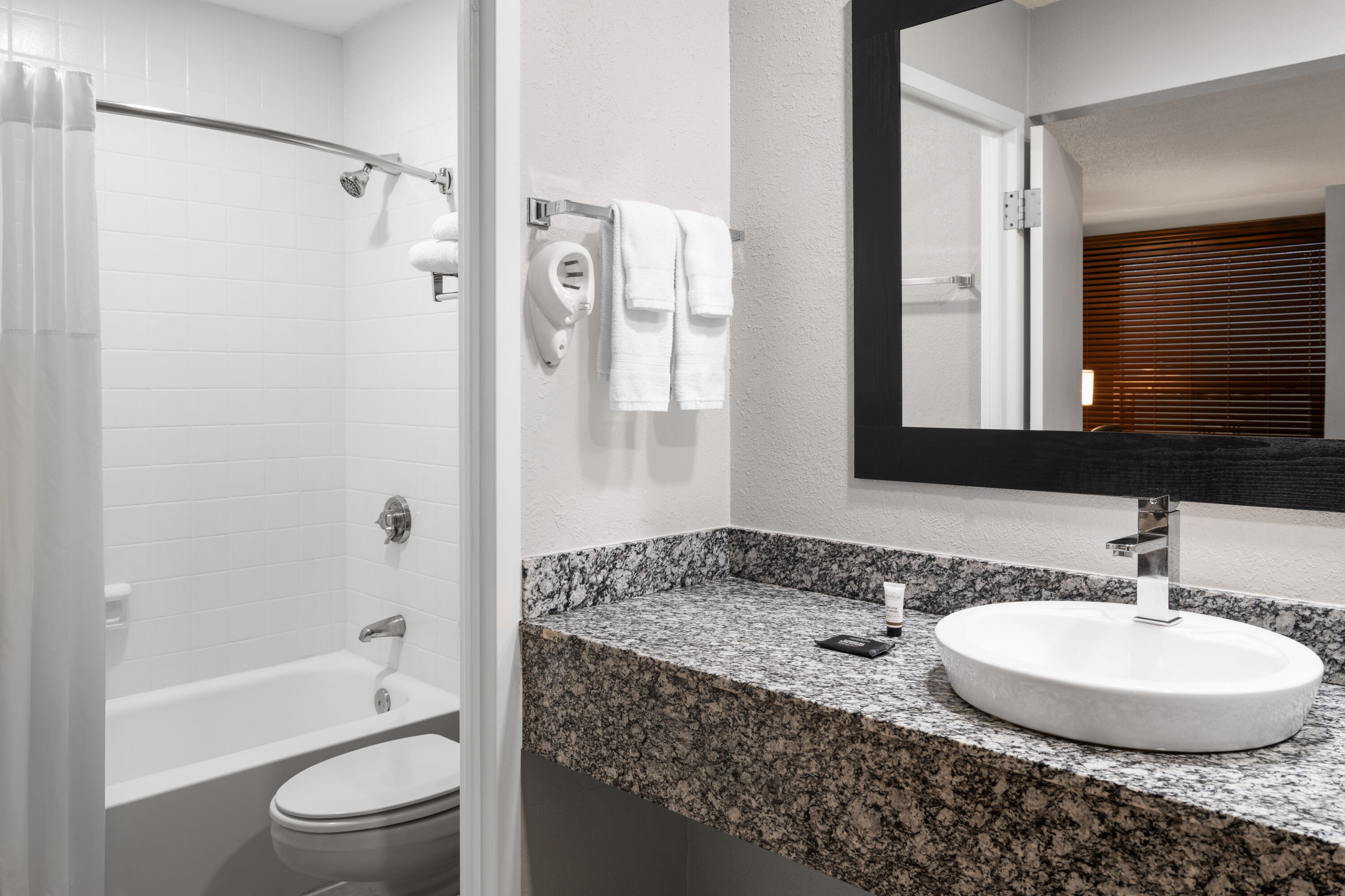 Guest room bath at the Baymont by Wyndham Great Falls City Center in Great Falls, Montana