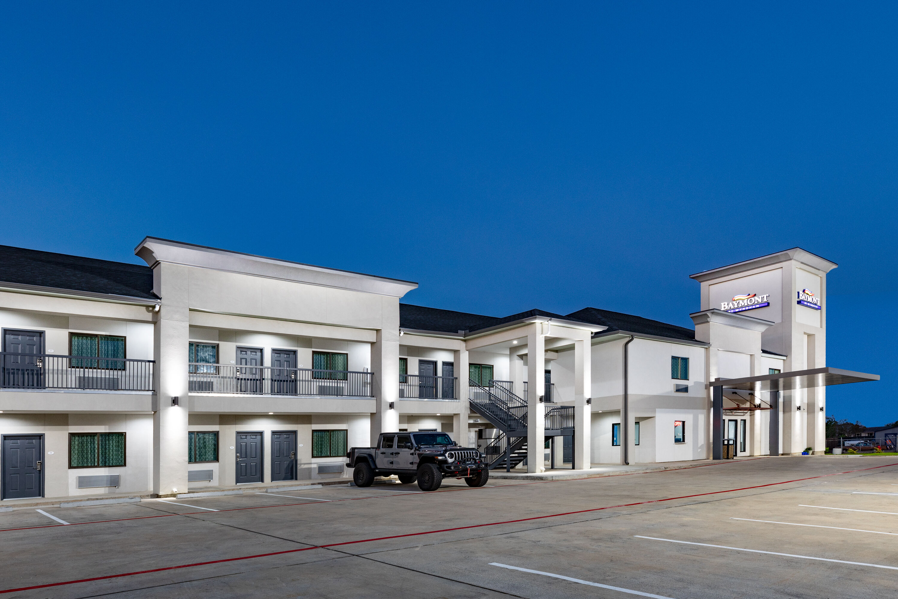 Exterior Dusk Image of Baymont by Wyndham Freeport Texas hotel in Freeport, Texas