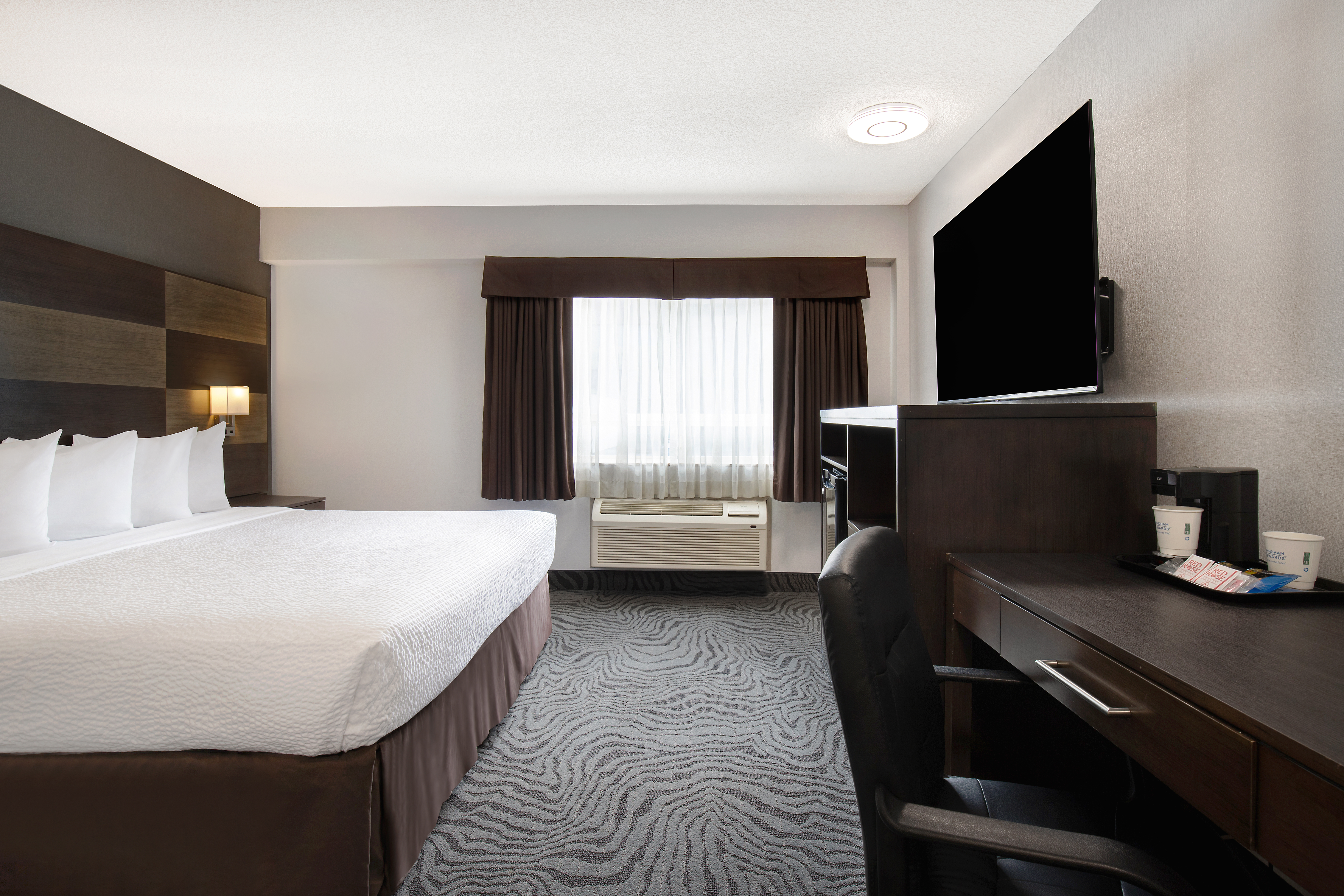 Guest room at the Days Inn by Wyndham Calgary South in Calgary, Alberta