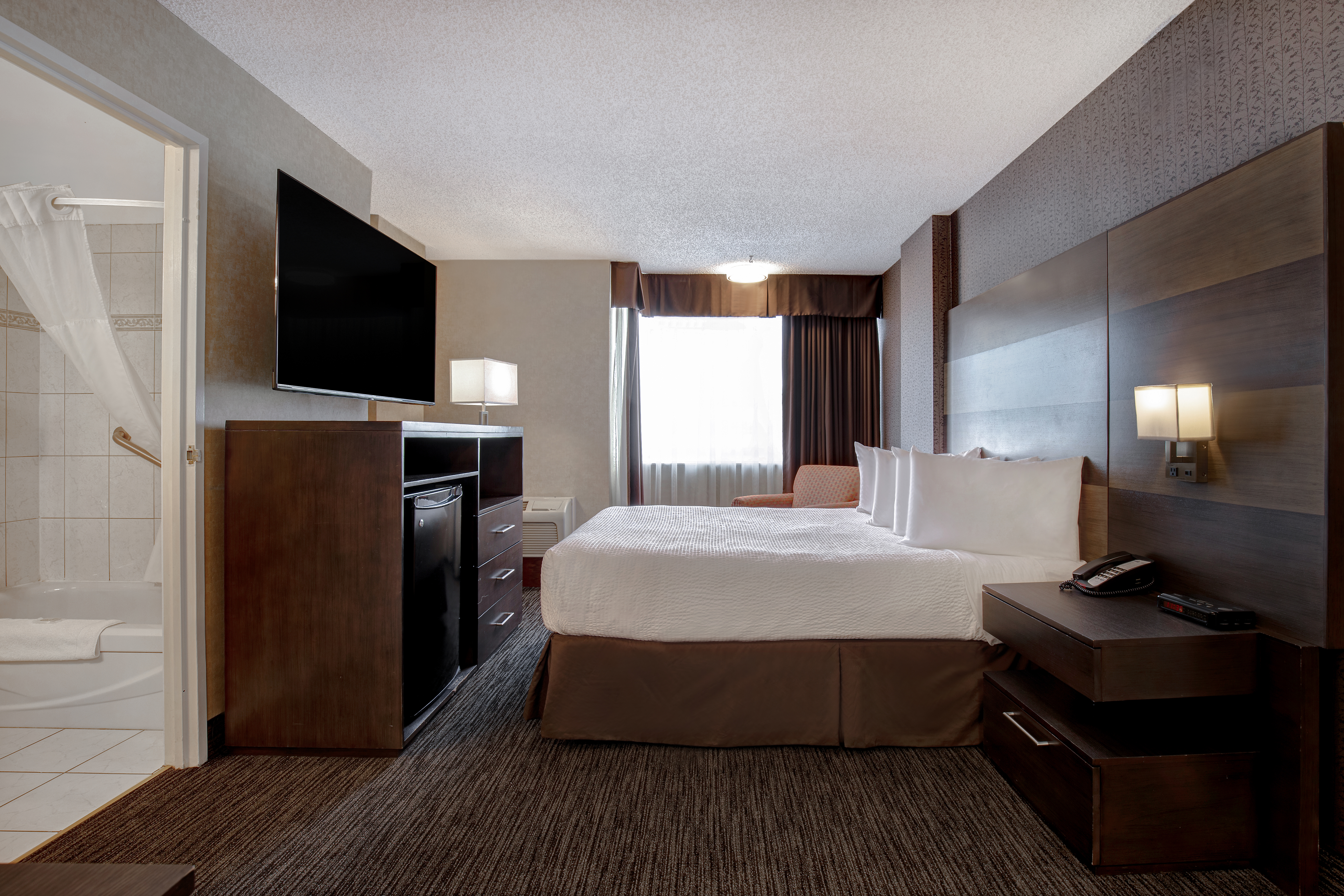 Guest room at the Days Inn by Wyndham Calgary South in Calgary, Alberta