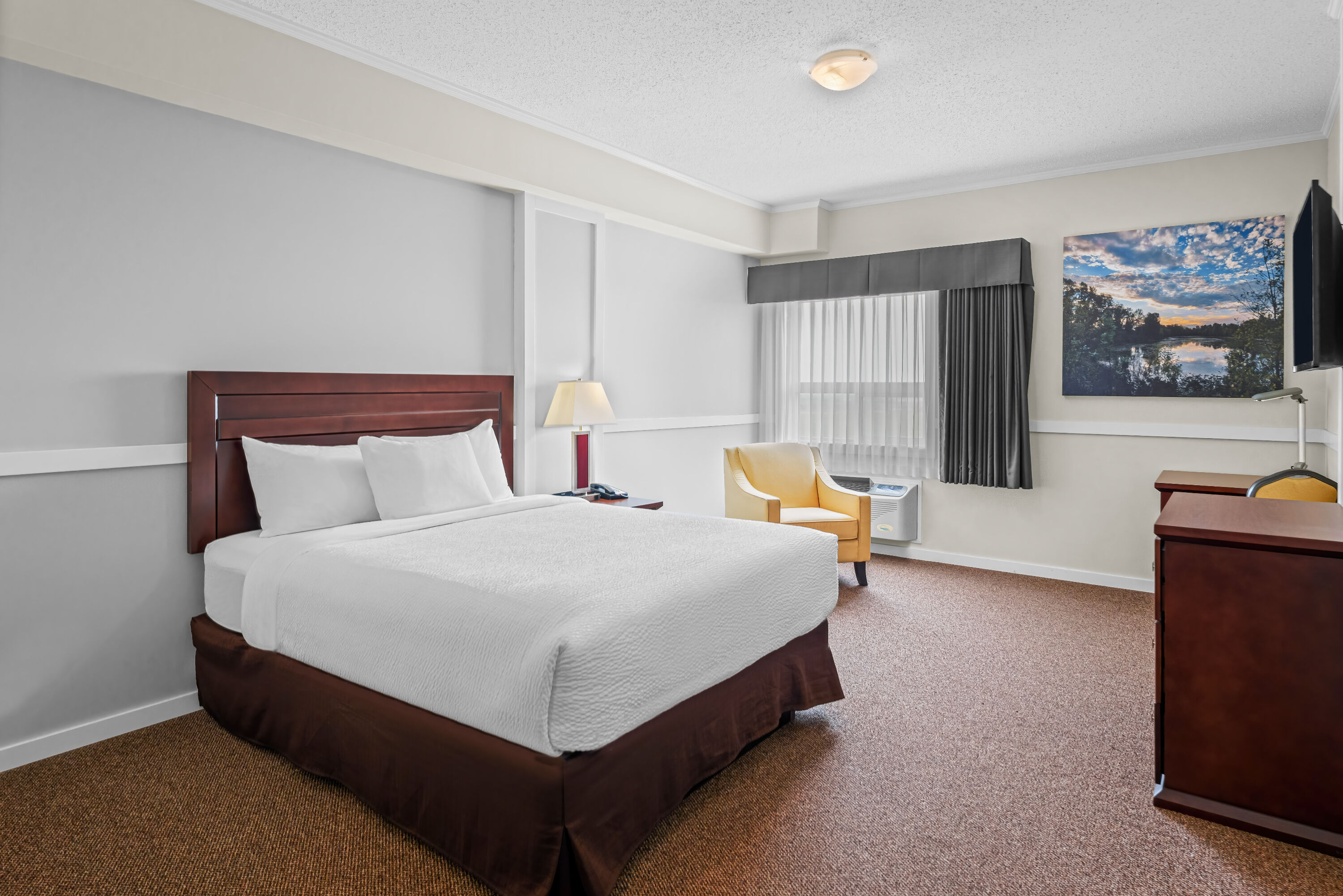 Queen bed guest room at the Days Inn by Wyndham Lamont in Lamont, Alberta