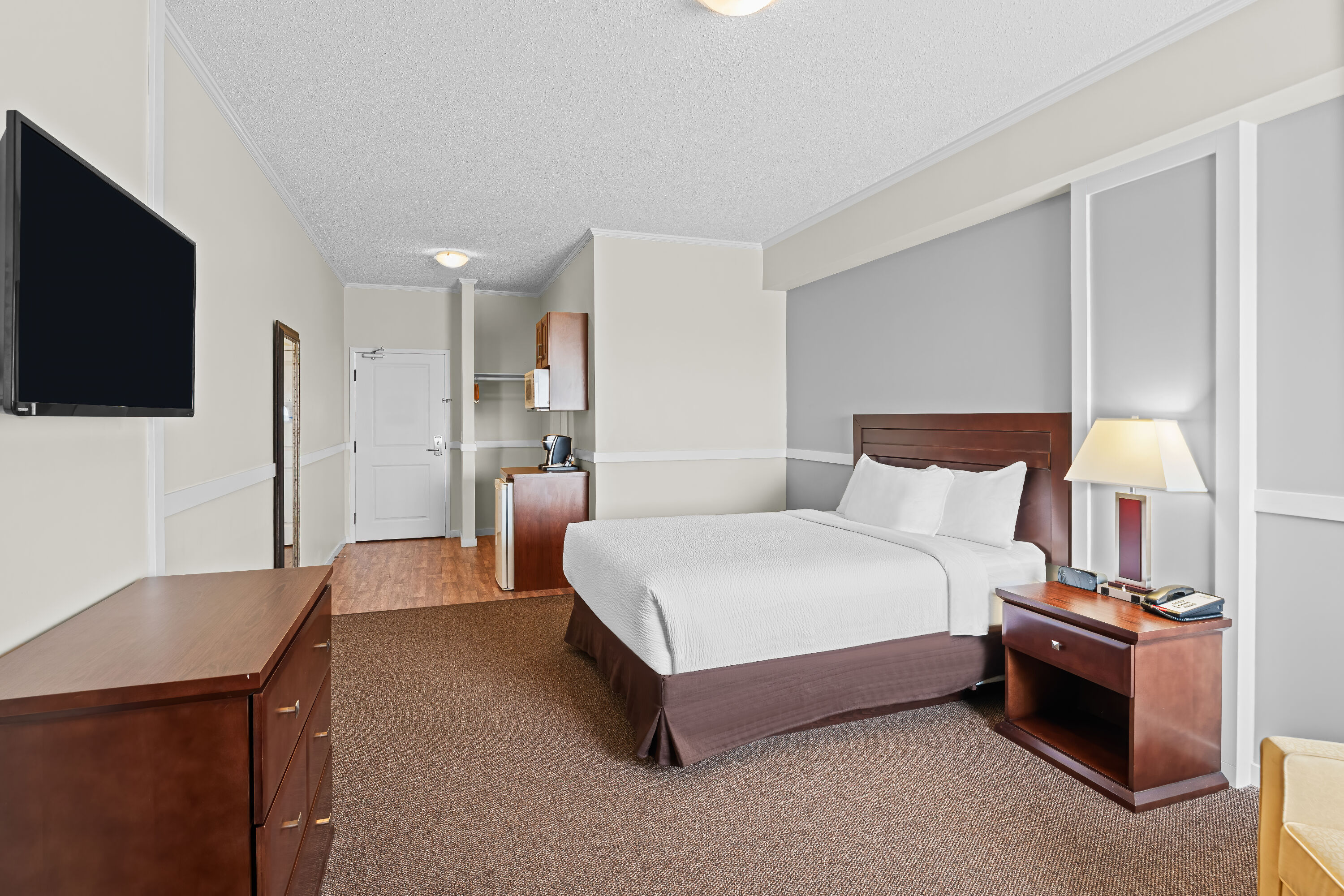 Queen bed guest room at the Days Inn by Wyndham Lamont in Lamont, Alberta