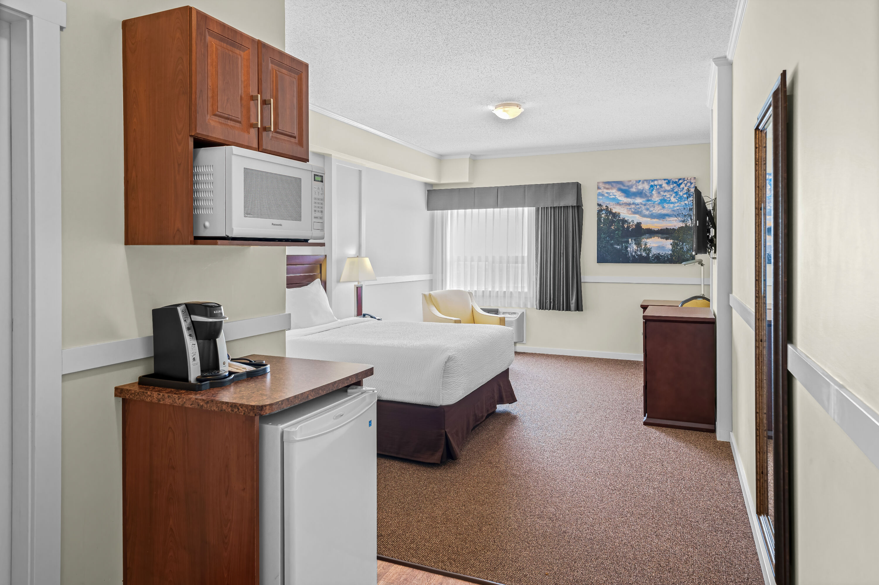 Queen bed guest room at the Days Inn by Wyndham Lamont in Lamont, Alberta