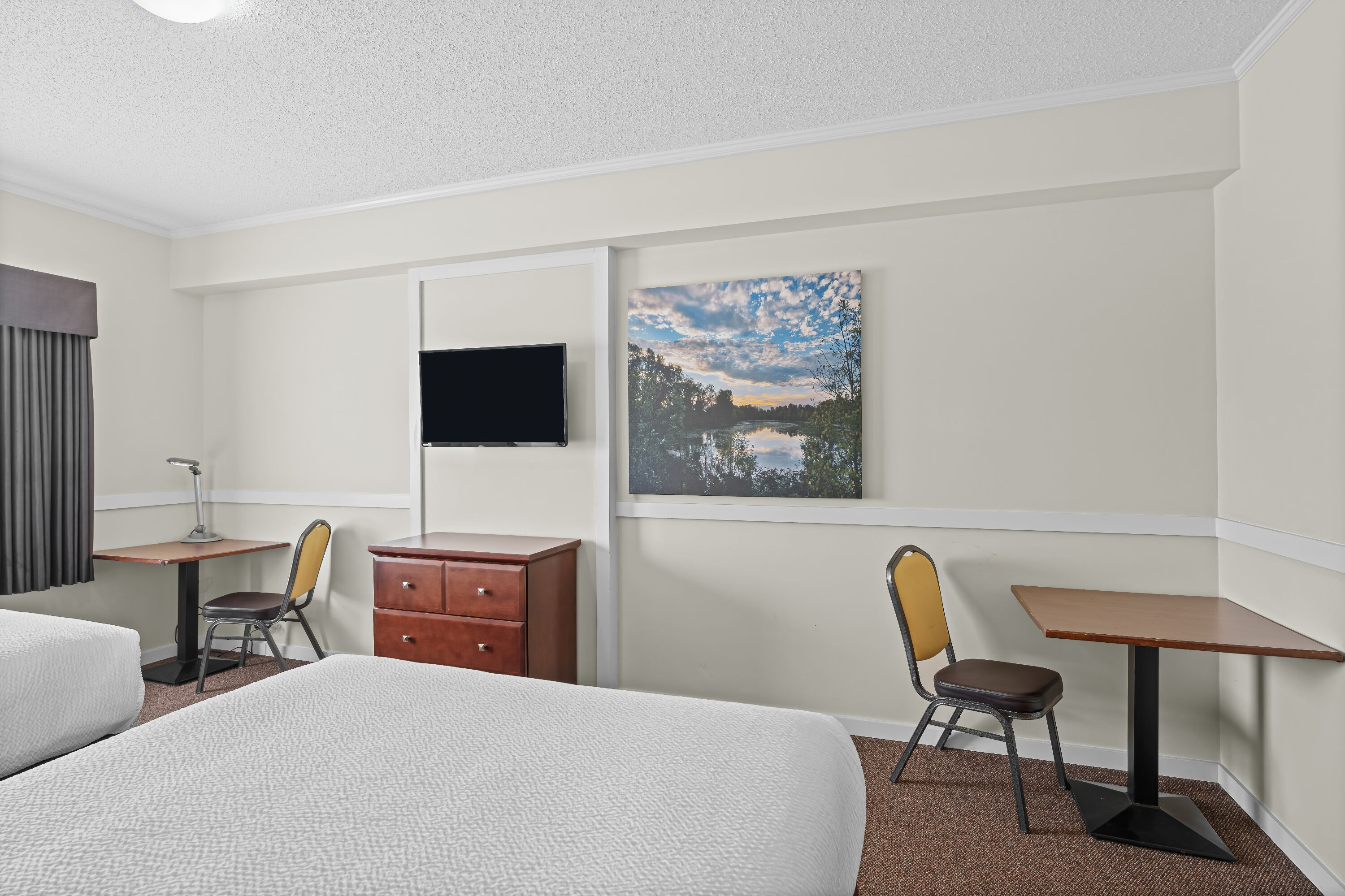 Queen bed guest room at the Days Inn by Wyndham Lamont in Lamont, Alberta