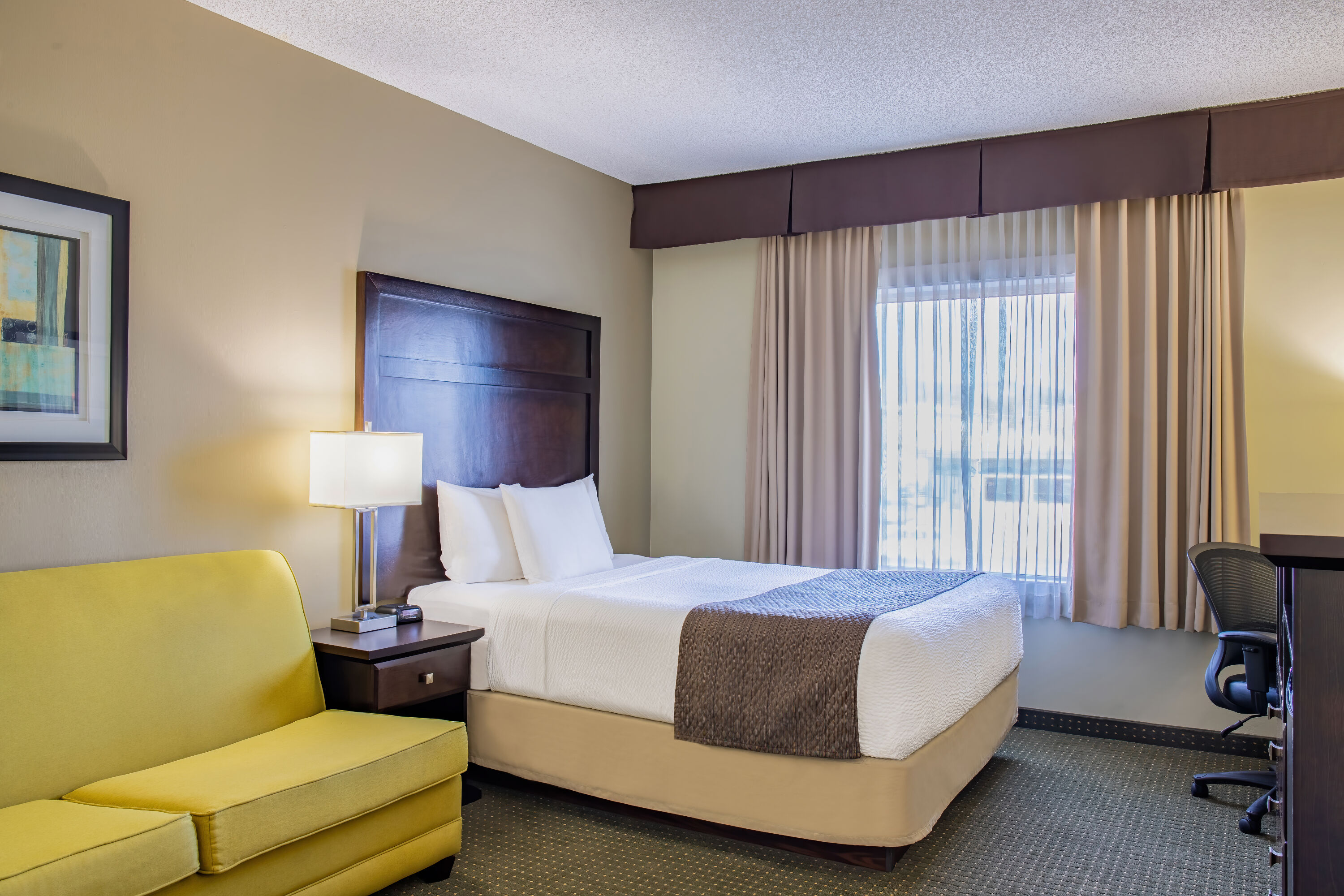 Queen bed guest room at the Days Inn by Wyndham Cranbrook Conference Centre in Cranbrook, British Columbia