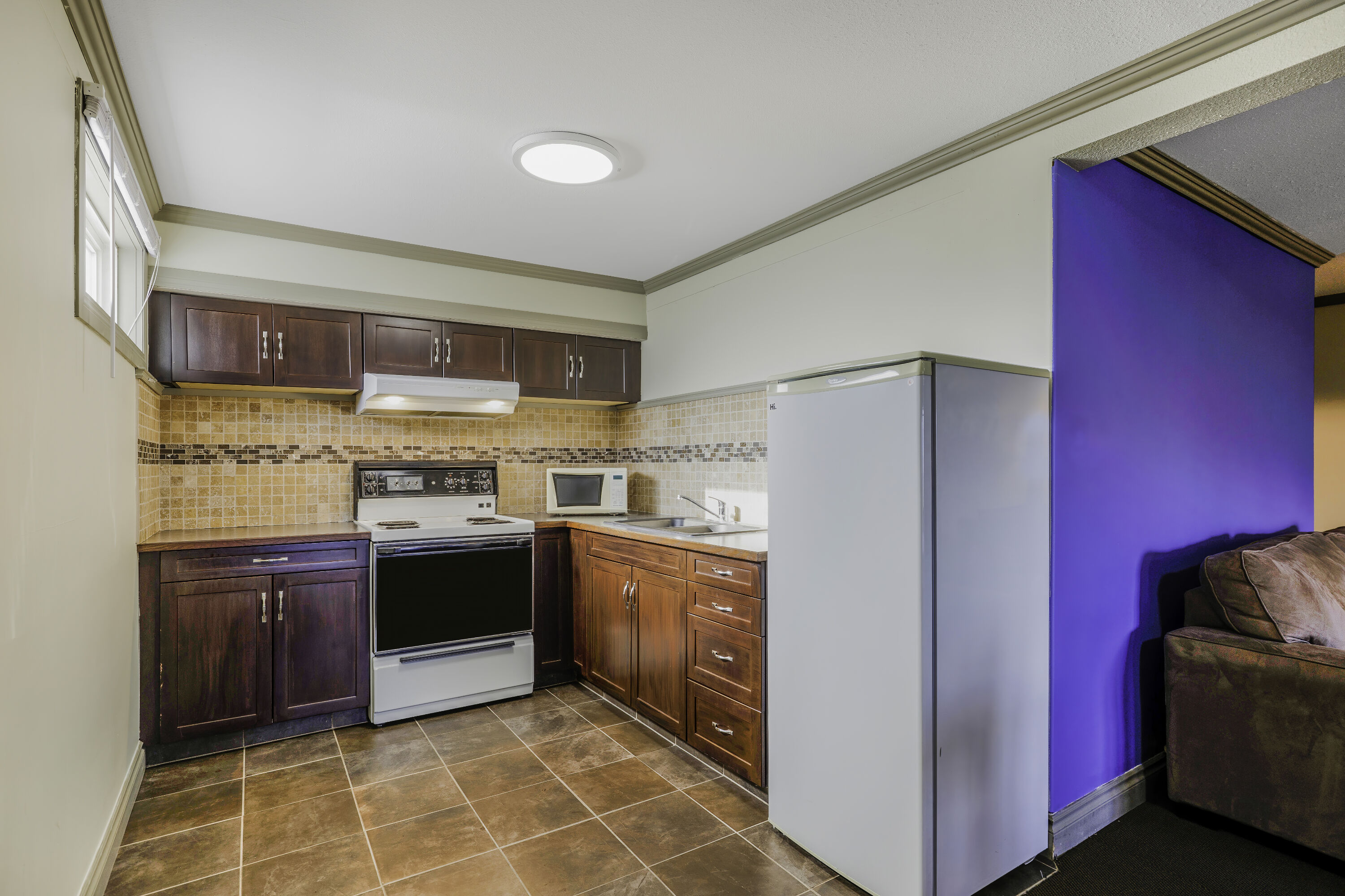 Queen bed guest room at the Days Inn by Wyndham Golden in Golden, British Columbia