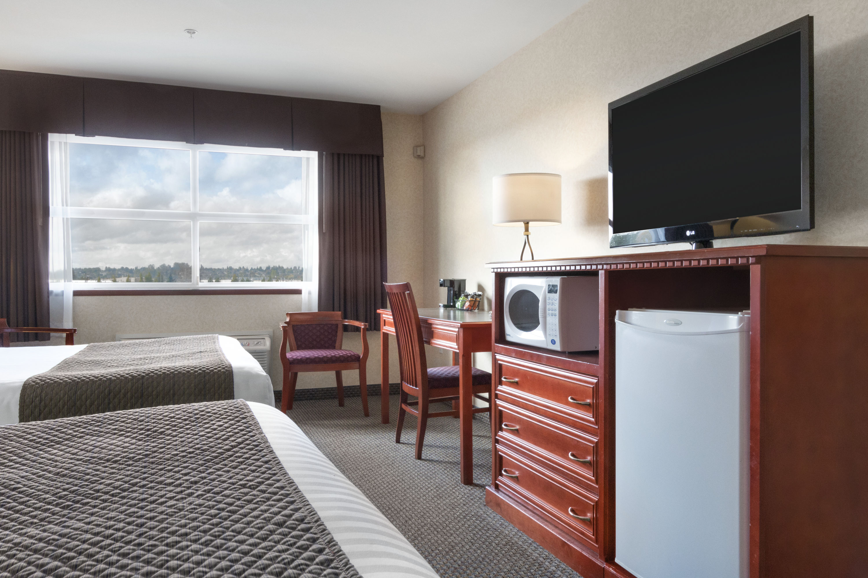 Guest room at the Days Inn & Suites by Wyndham Langley in Langley, British Columbia