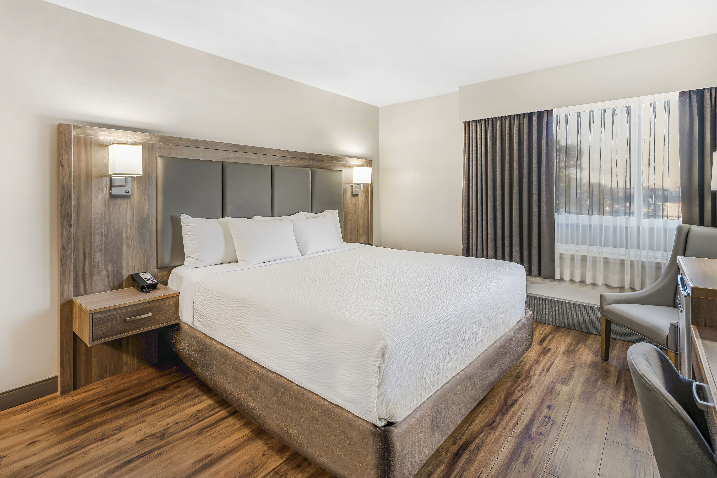 King bed guest room at the Days Inn by Wyndham Victoria On The Harbour in Victoria, British Columbia