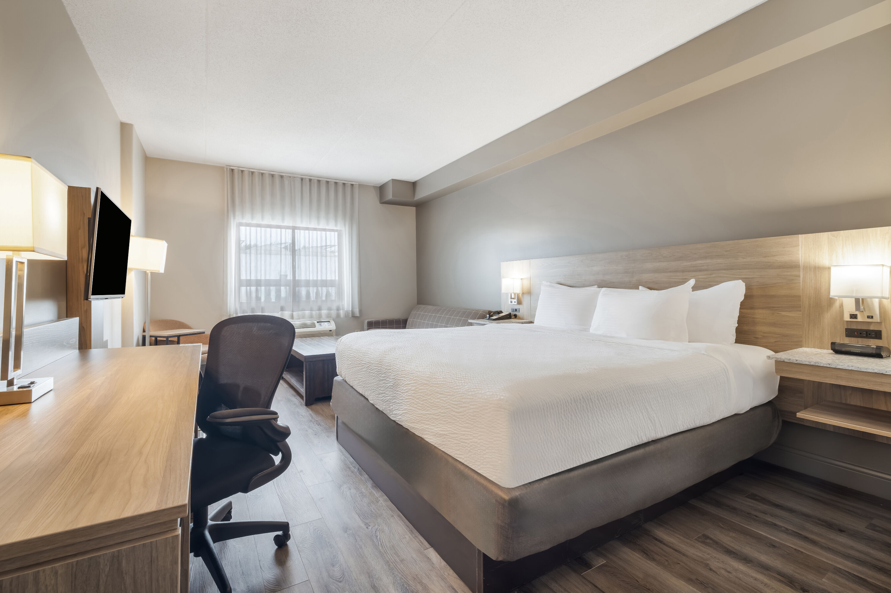 King bed guest room at the Days Inn by Wyndham Leamington in Leamington, Ontario