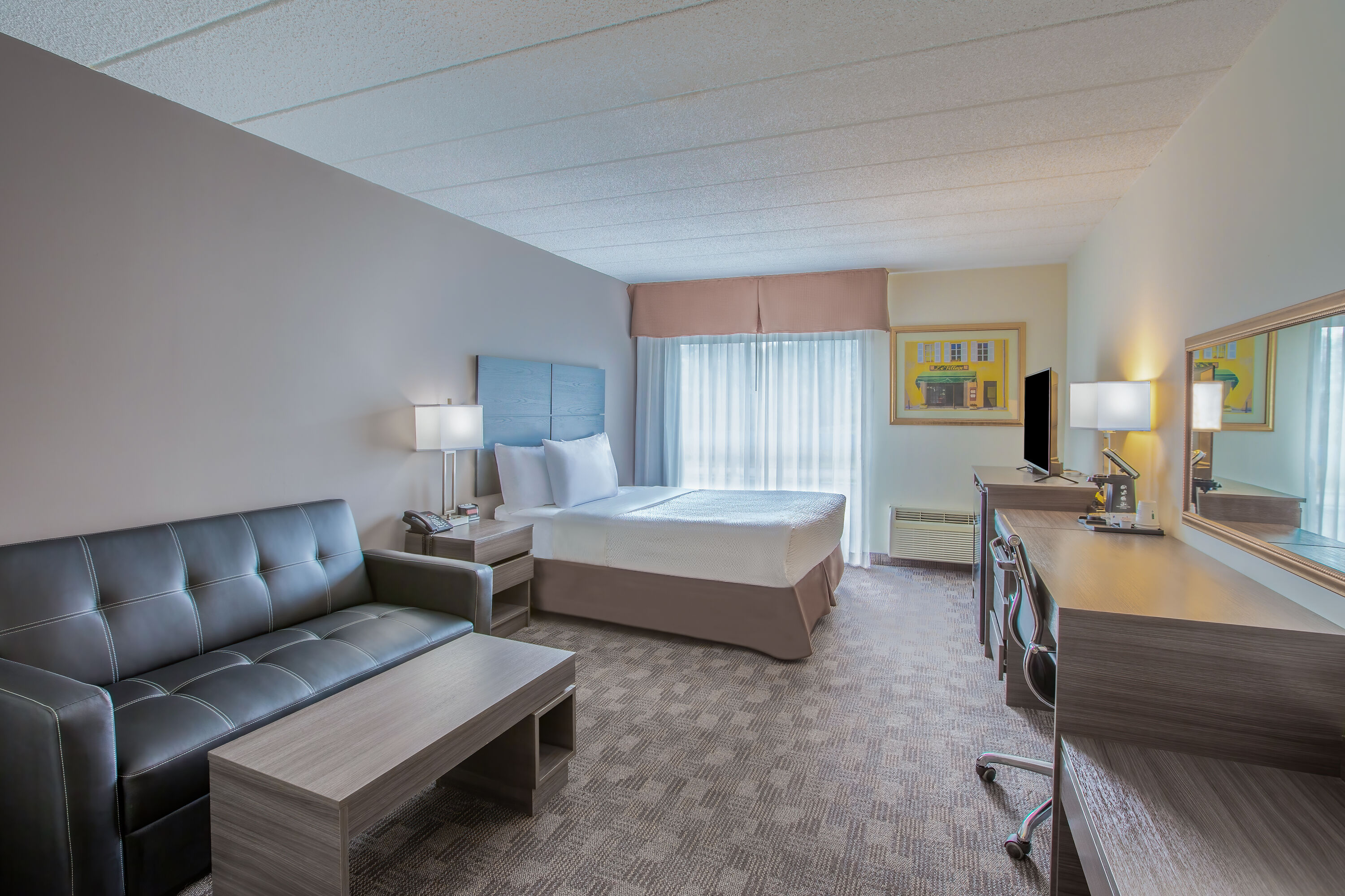 Queen bed guest room at the Days Inn by Wyndham Sudbury & Conference Centre in Sudbury, Ontario