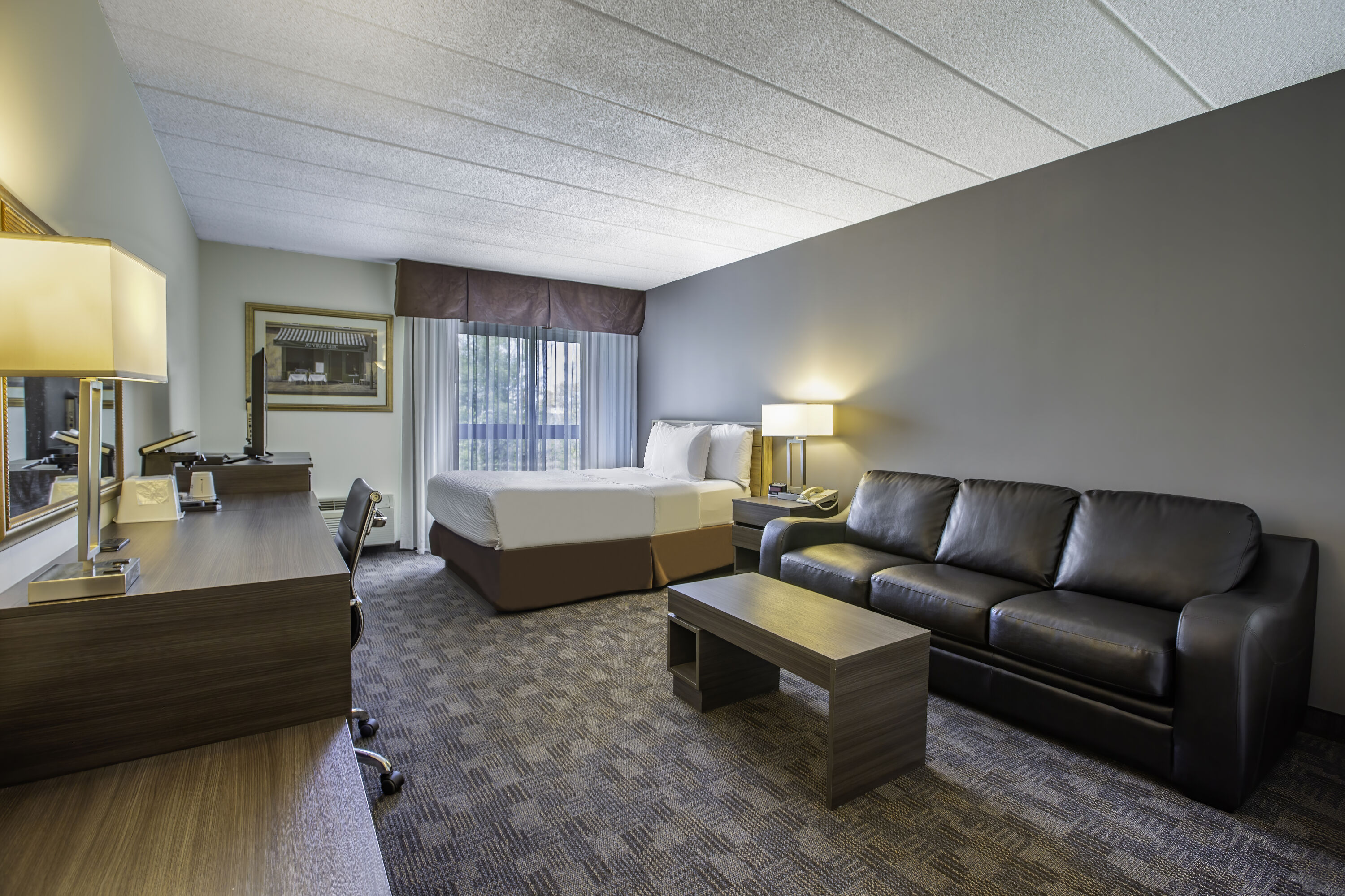 Queen bed guest room at the Days Inn by Wyndham Sudbury & Conference Centre in Sudbury, Ontario
