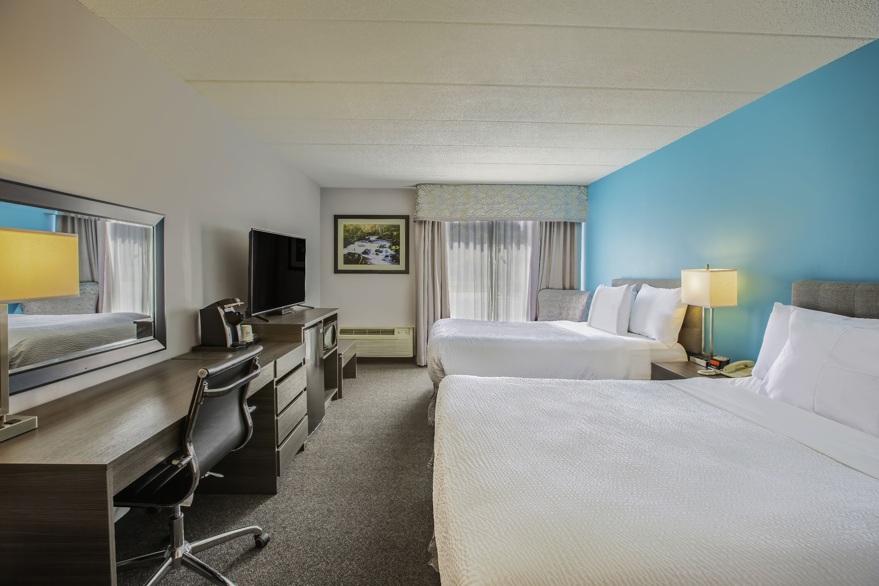 Queen bed guest room at the Days Inn by Wyndham Sudbury & Conference Centre in Sudbury, Ontario