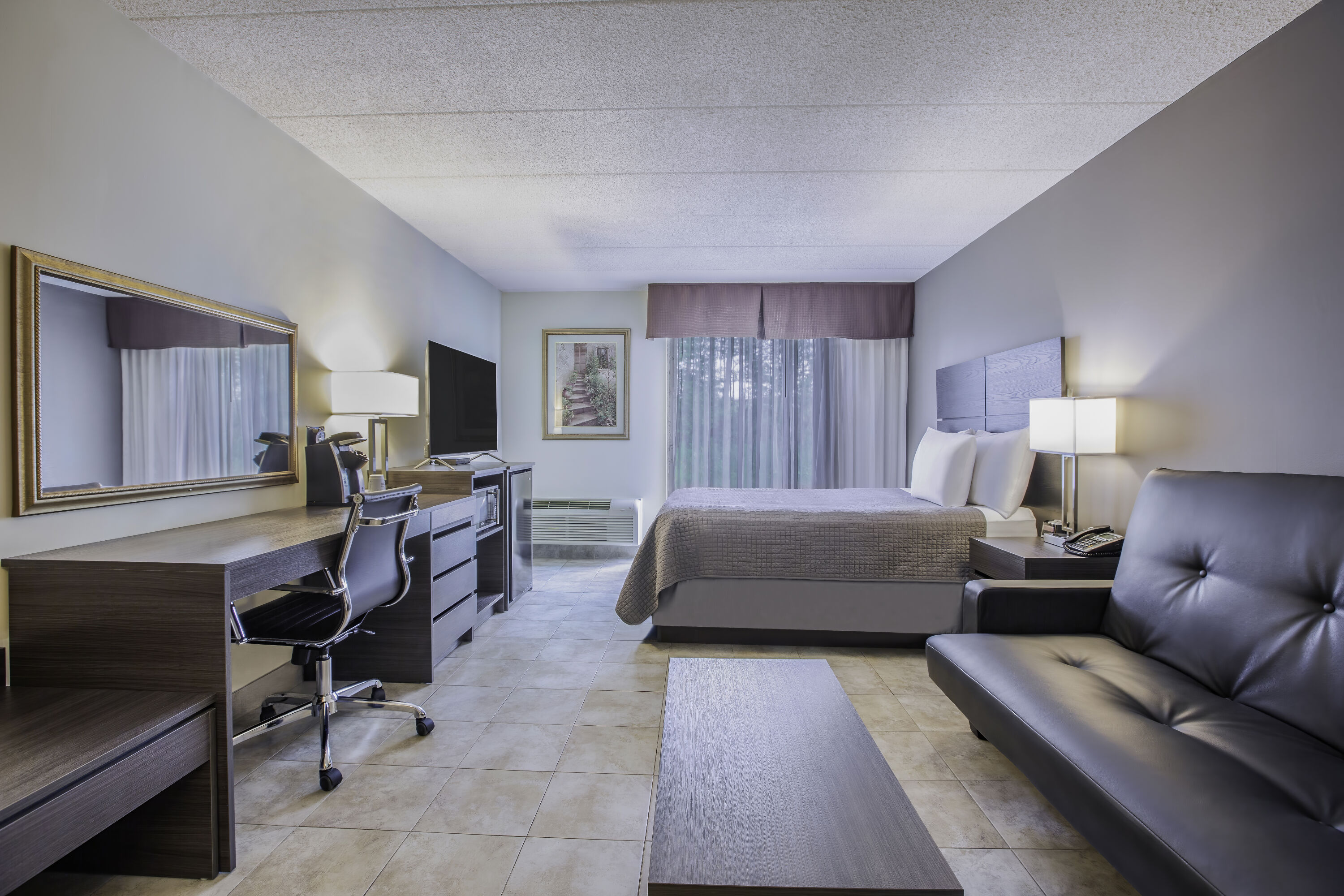 Queen bed guest room at the Days Inn by Wyndham Sudbury & Conference Centre in Sudbury, Ontario