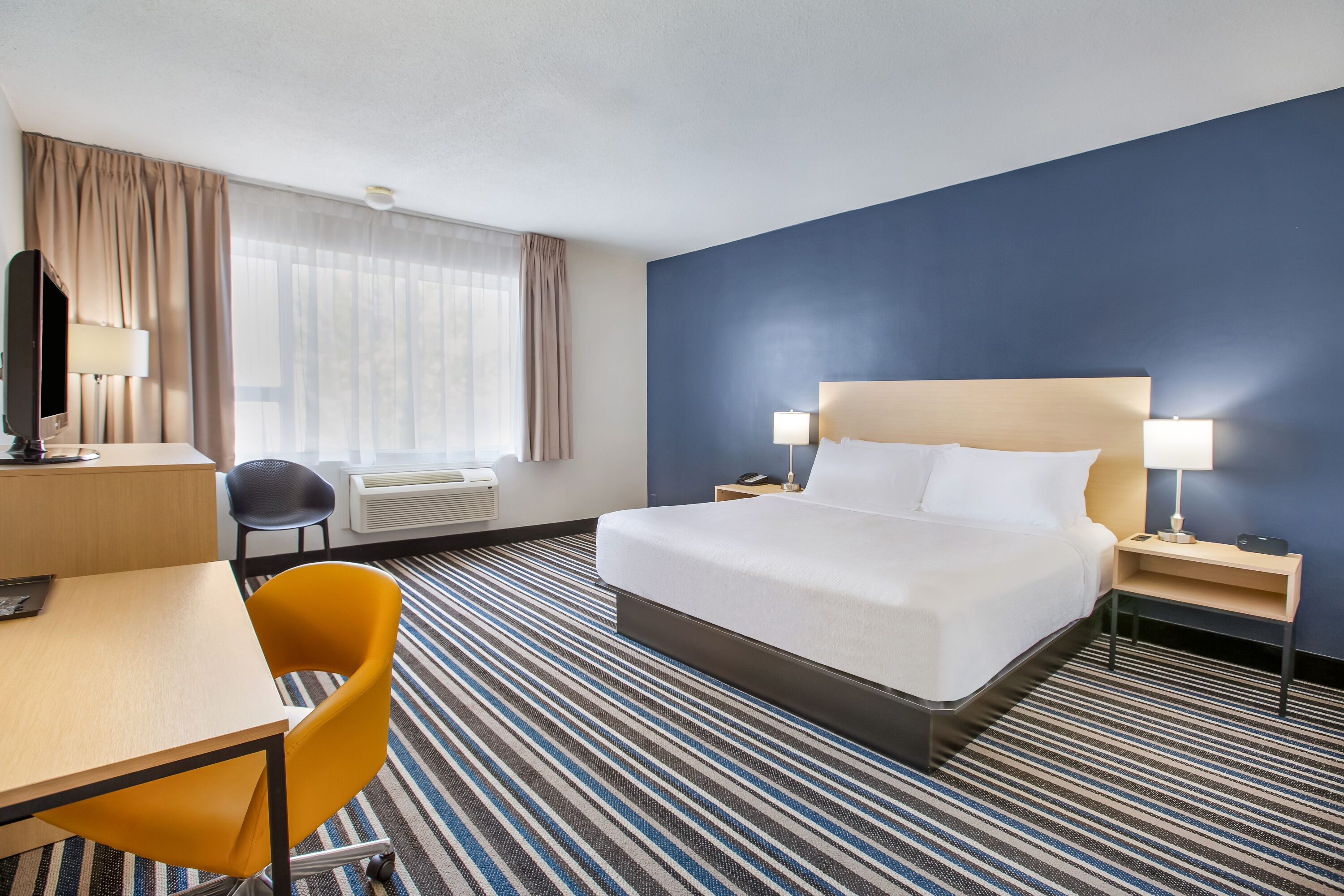 King bed guest room at the Days Inn by Wyndham Montreal Airport Conference Centre in Montreal, Quebec