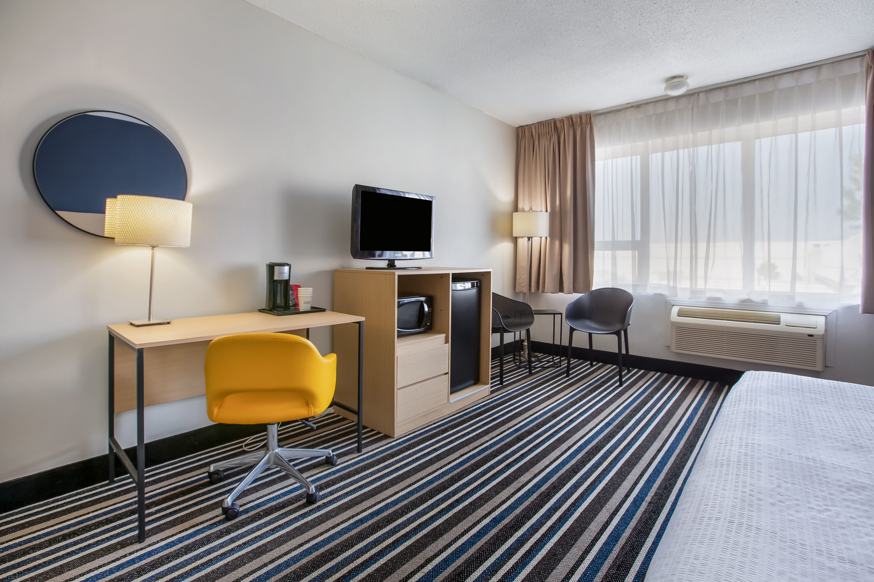 King bed guest room at the Days Inn by Wyndham Montreal Airport Conference Centre in Montreal, Quebec