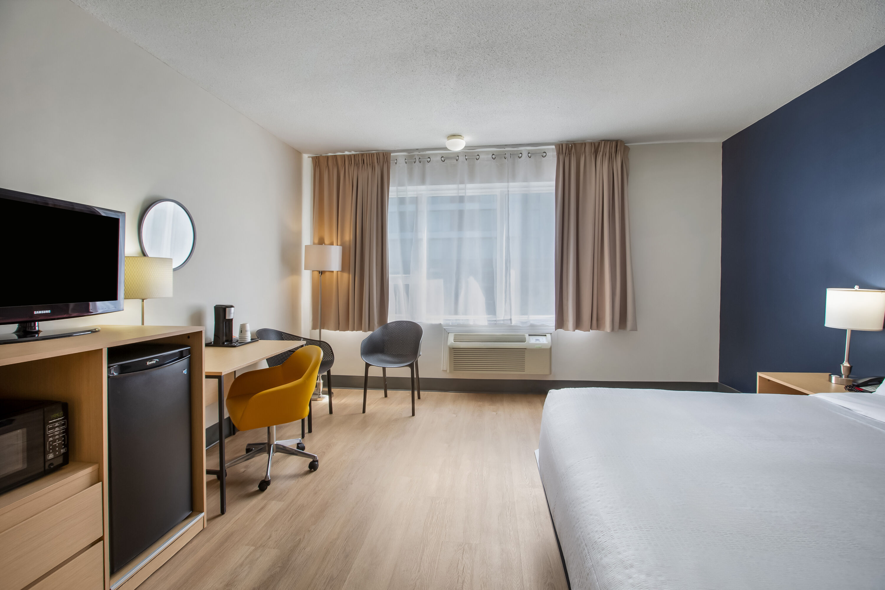 King bed guest room at the Days Inn by Wyndham Montreal Airport Conference Centre in Montreal, Quebec