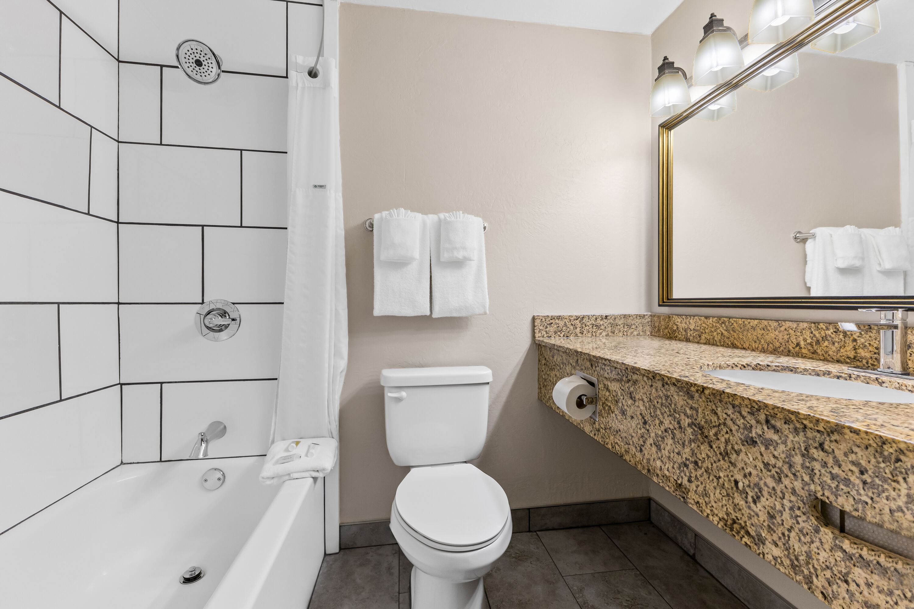 King bed guest room at the Days Inn & Suites by Wyndham Mesa Near Phoenix in Mesa, Arizona