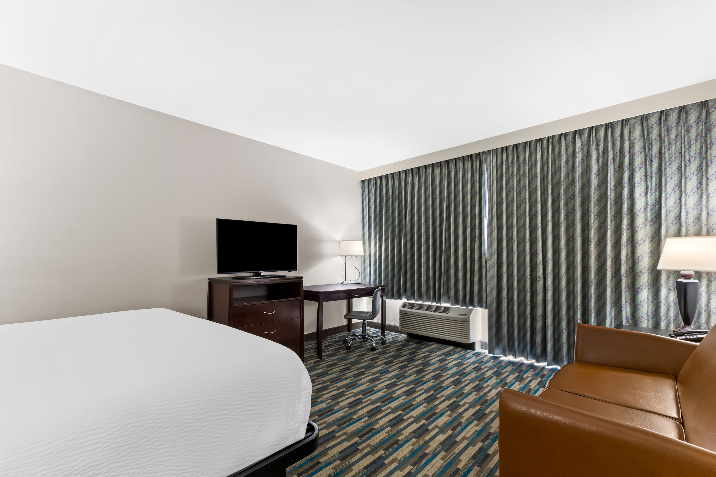 King bed guest room at the Days Inn & Suites by Wyndham Mesa Near Phoenix in Mesa, Arizona