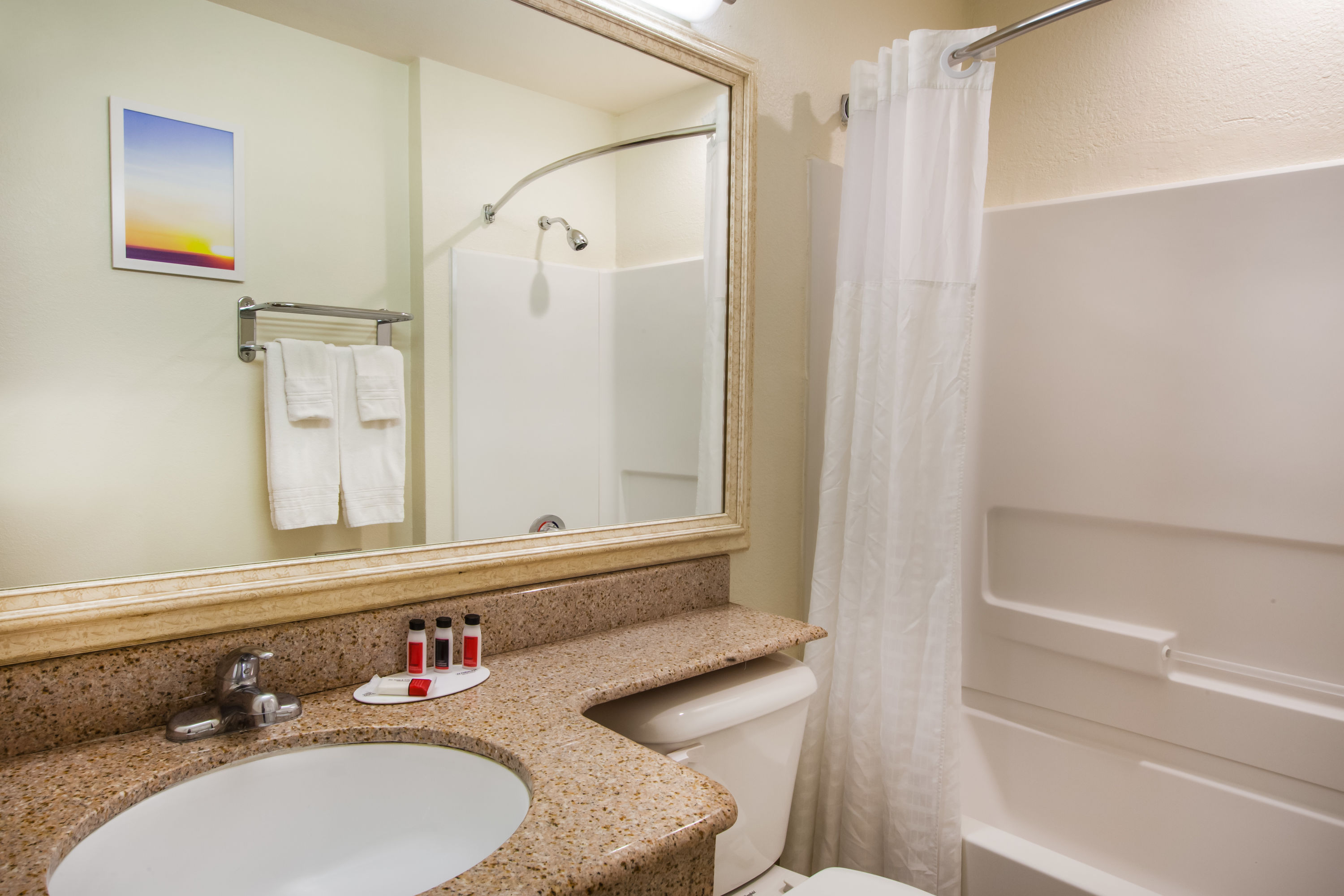 Guest room bath at the Days Inn & Suites by Wyndham Antioch in Antioch, California