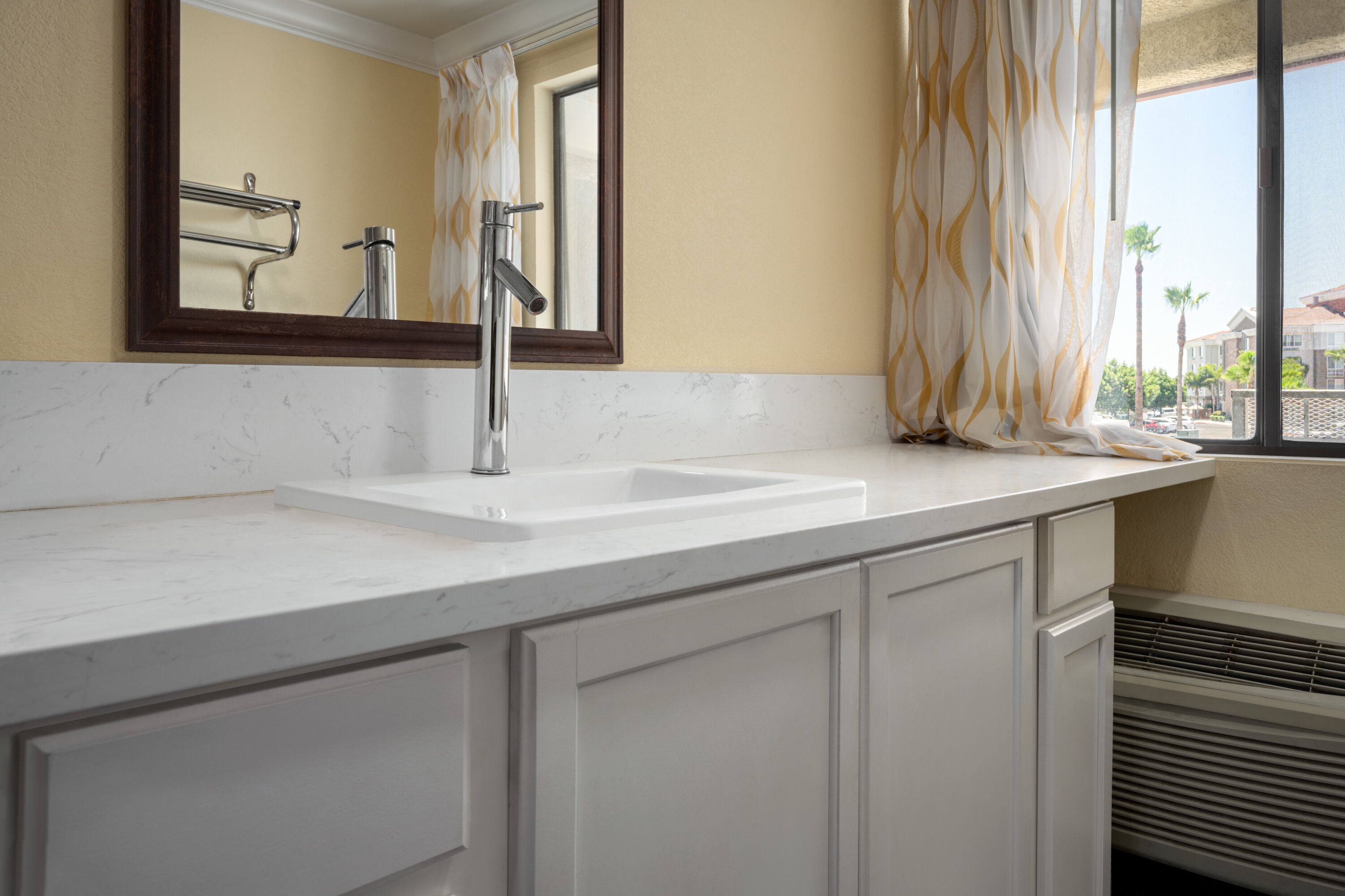 Guest room bath at the Days Inn by Wyndham Fresno South in Fresno, California