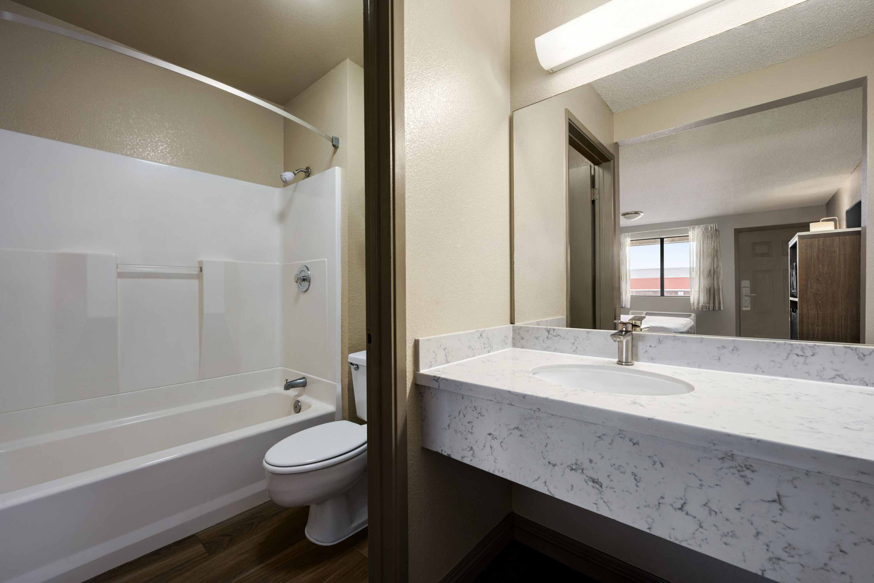 Guest room bath at the Days Inn by Wyndham Fresno South in Fresno, California