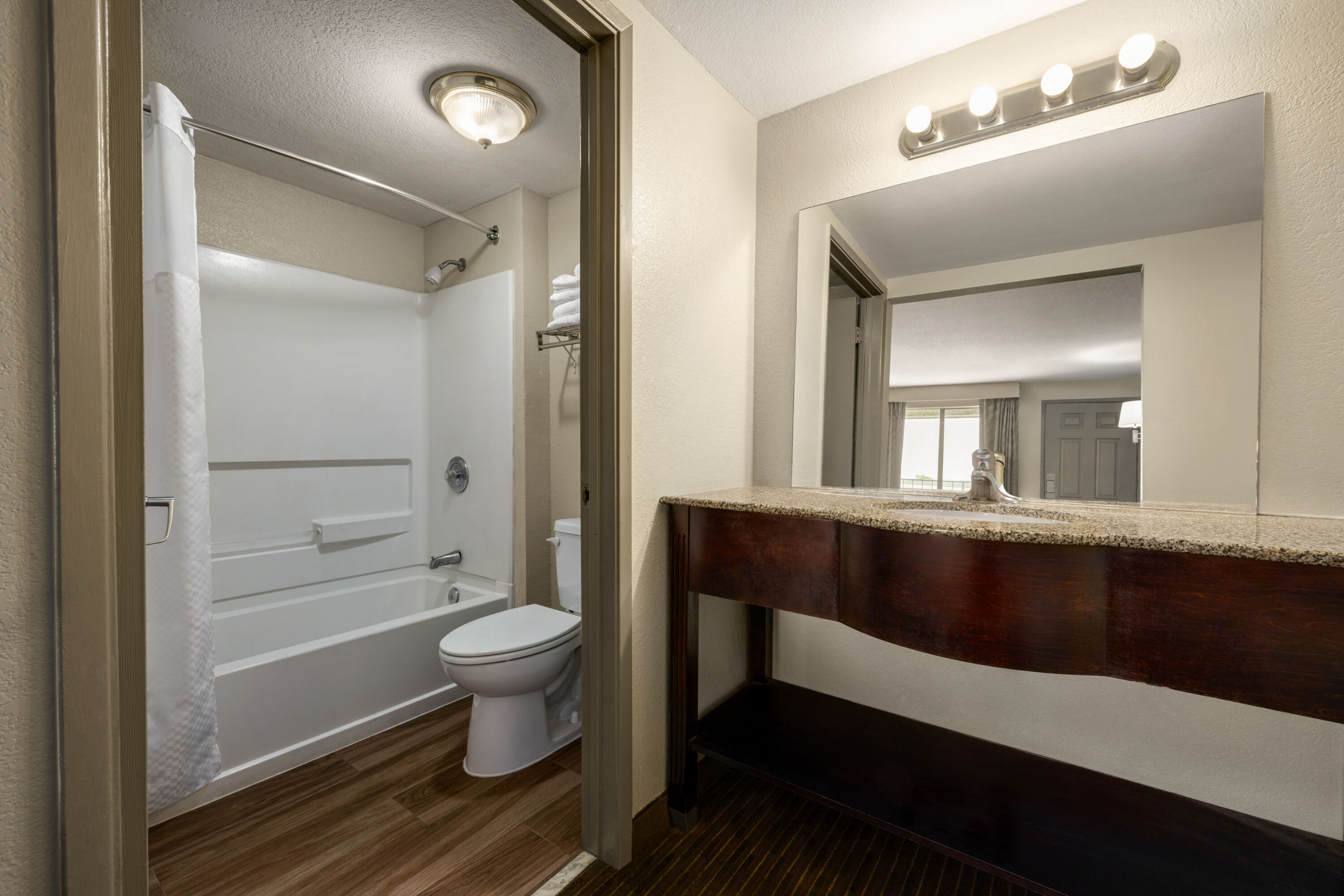 Guest room bath at the Days Inn by Wyndham Fresno South in Fresno, California