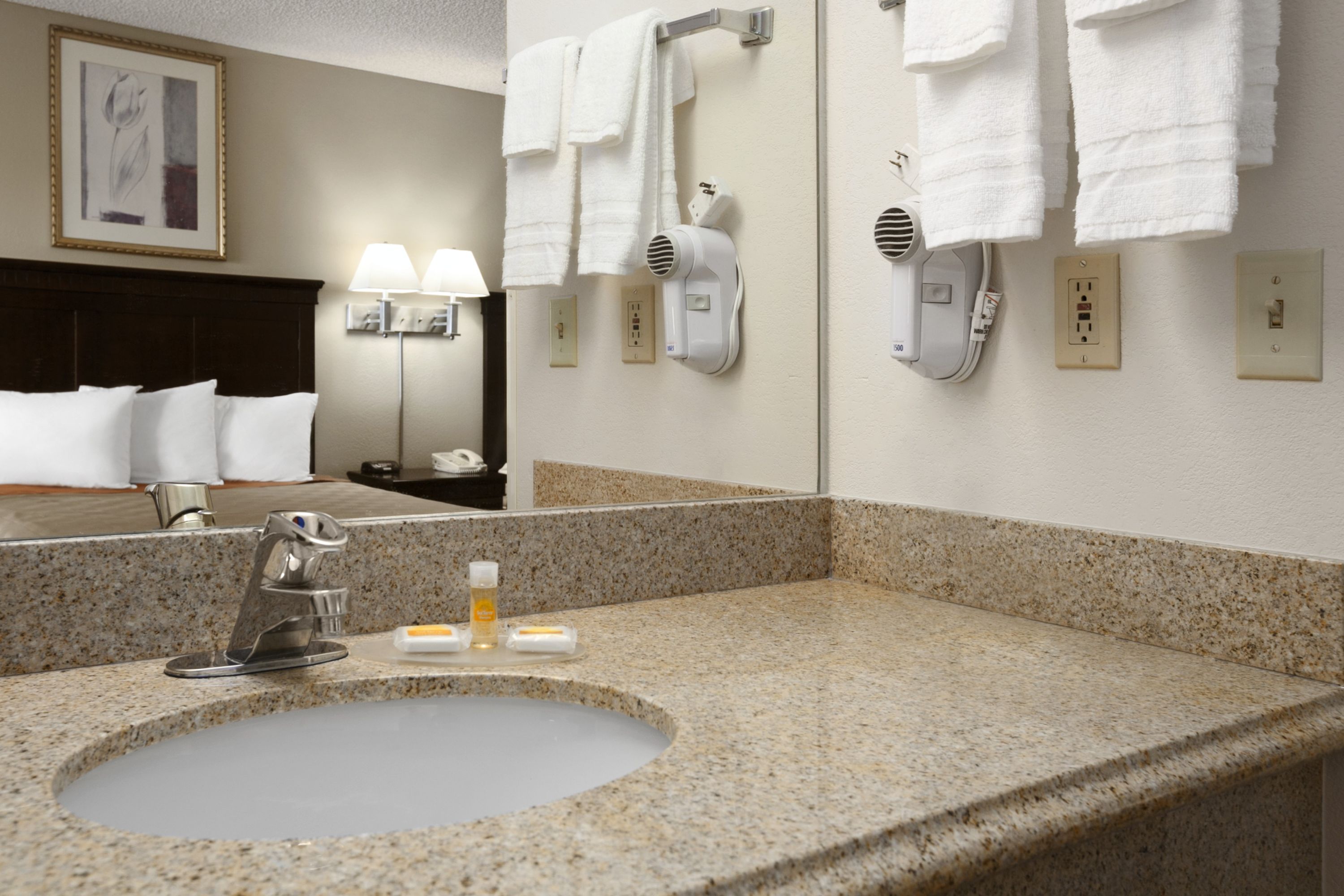 Guest room bath at the Days Inn & Suites by Wyndham Rancho Cordova in Rancho Cordova, California
