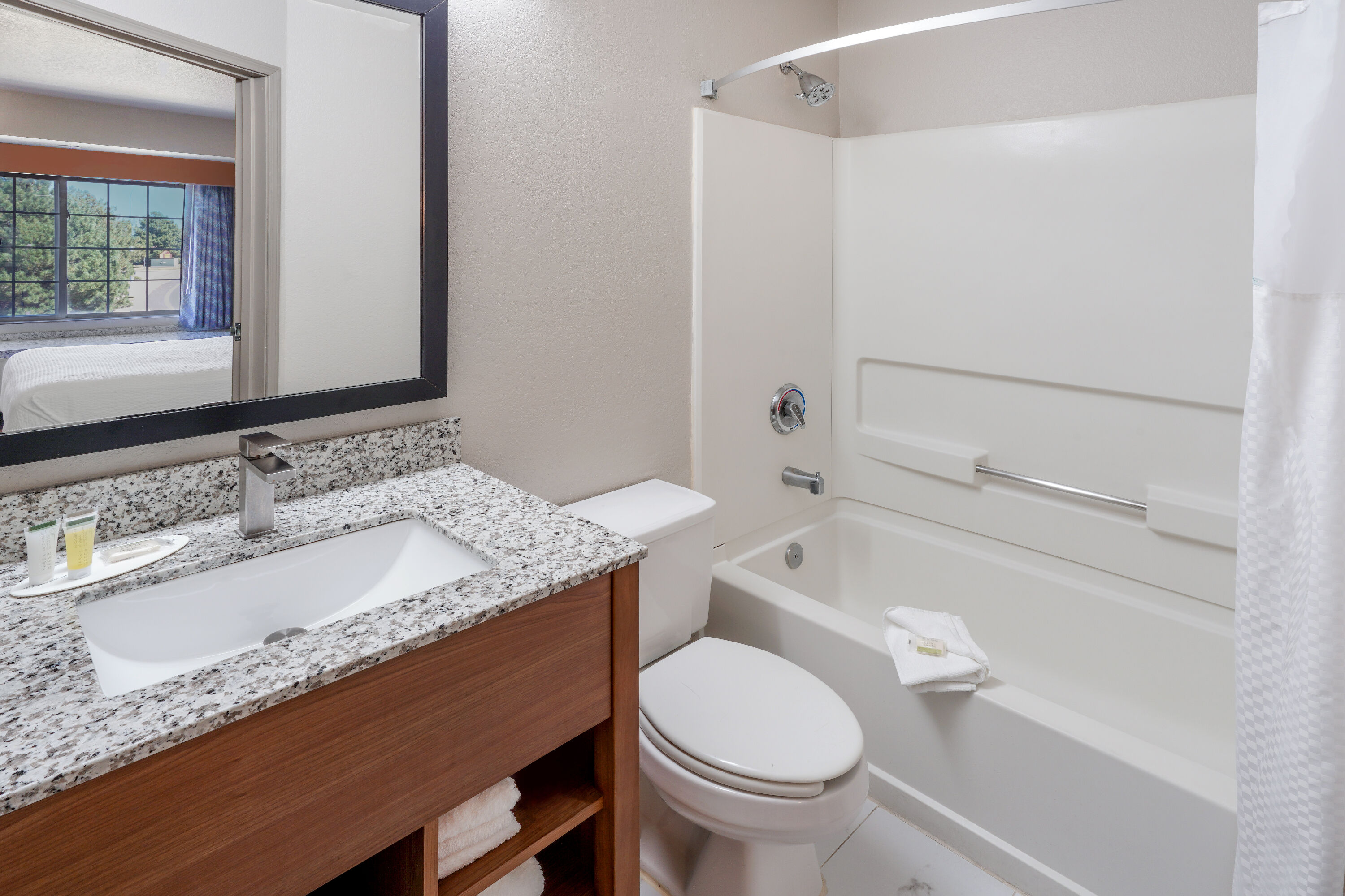 Guest room bath at the Days Inn & Suites by Wyndham Greeley in Greeley, Colorado