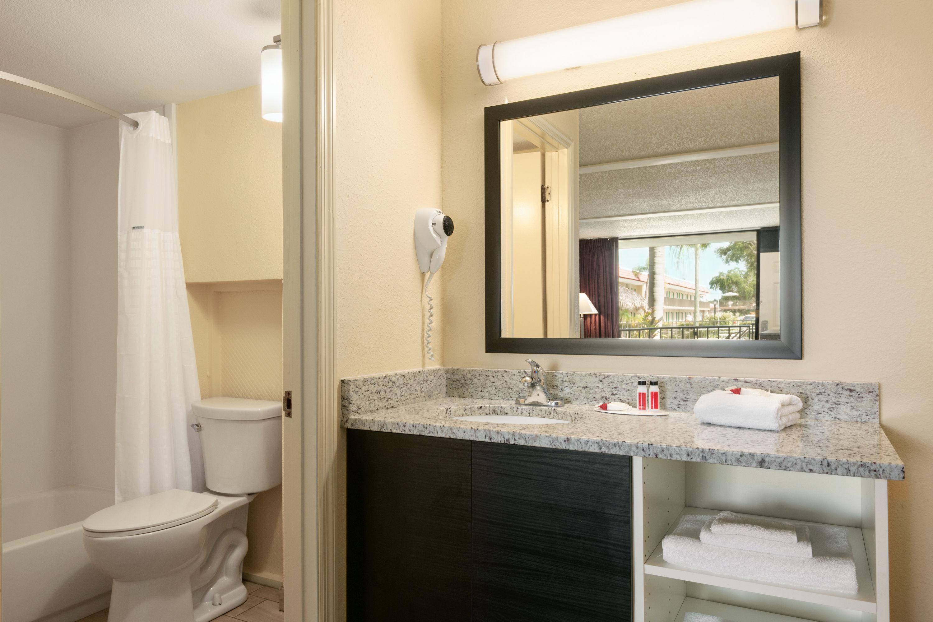 Guest room bath at the Days Inn by Wyndham Clearwater/Gulf to Bay in Clearwater, Florida
