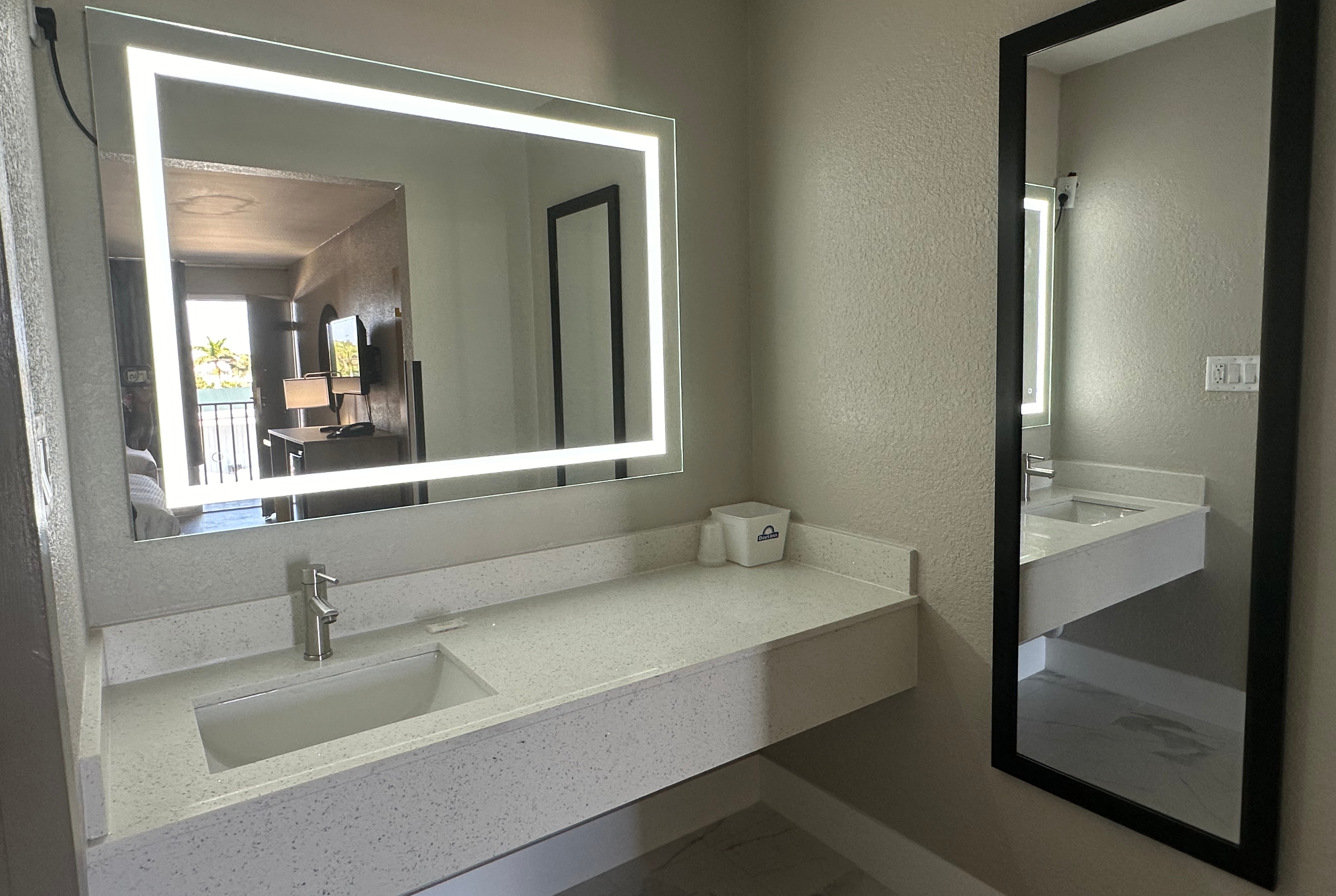 Guest room bath at the Days Inn by Wyndham Fort Myers in Fort Myers, Florida