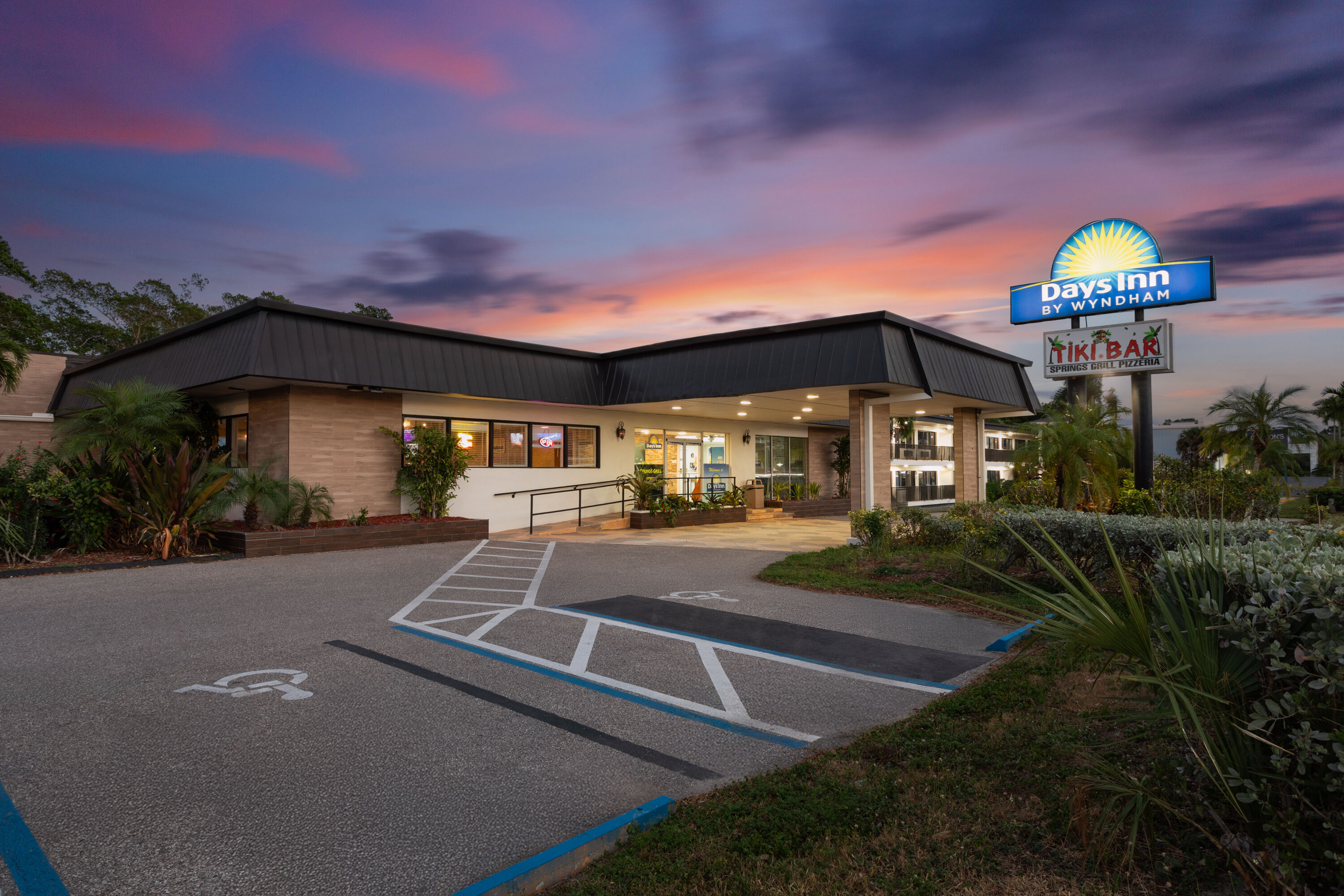 Exterior Dusk Image of Days Inn by Wyndham Fort Myers Springs Resort hotel in Fort Myers, Florida
