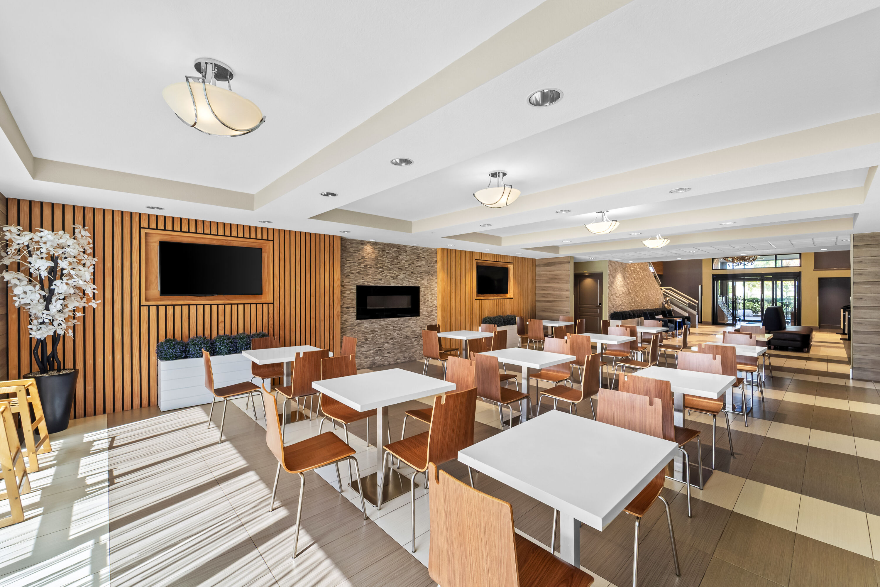 Days Inn & Suites by Wyndham Fort Myers Near JetBlue Park restaurant breakfast area with seating in Fort Myers, Florida