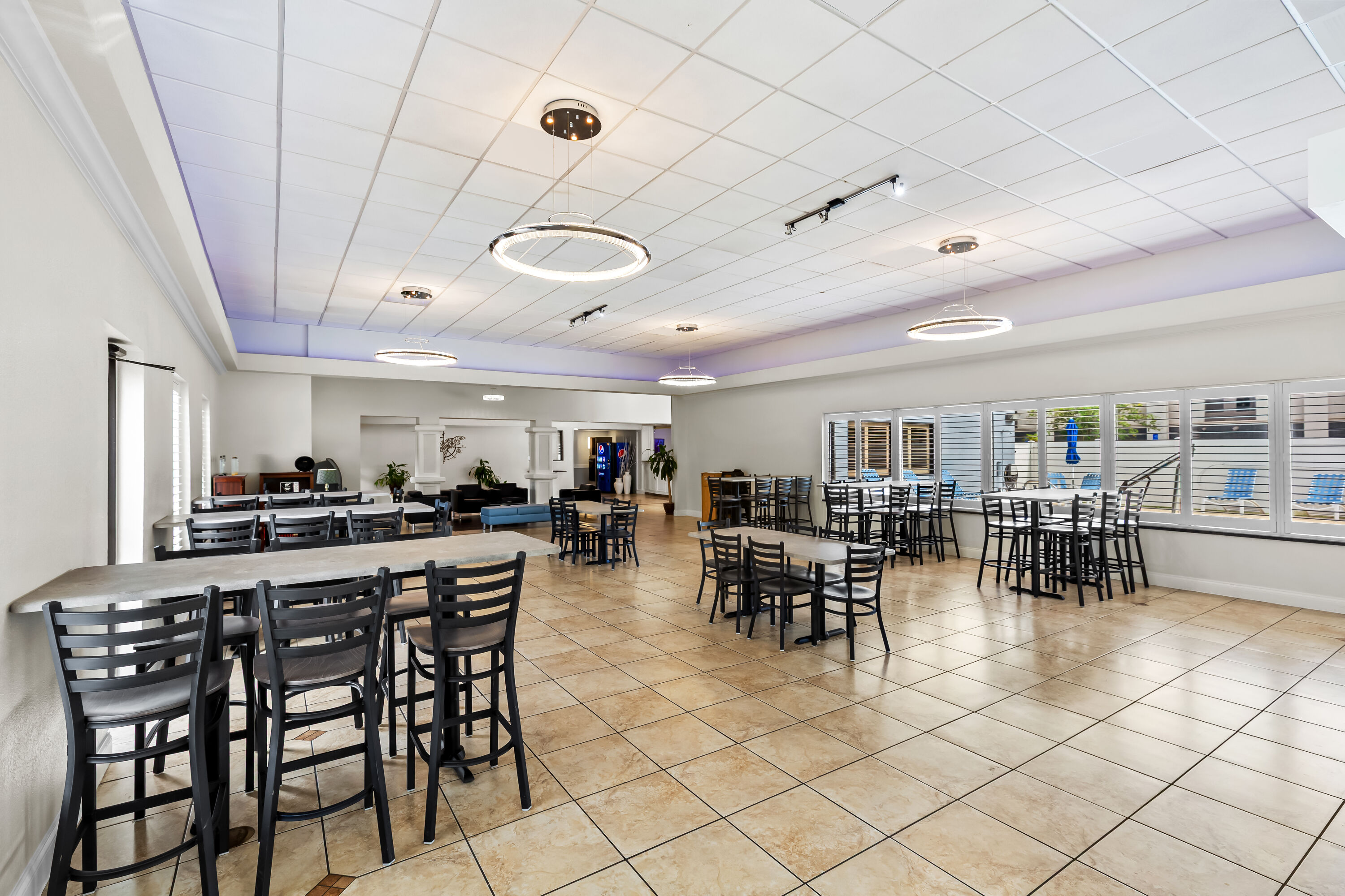 Days Inn & Suites by Wyndham Lakeland restaurant breakfast area with seating in Lakeland, Florida