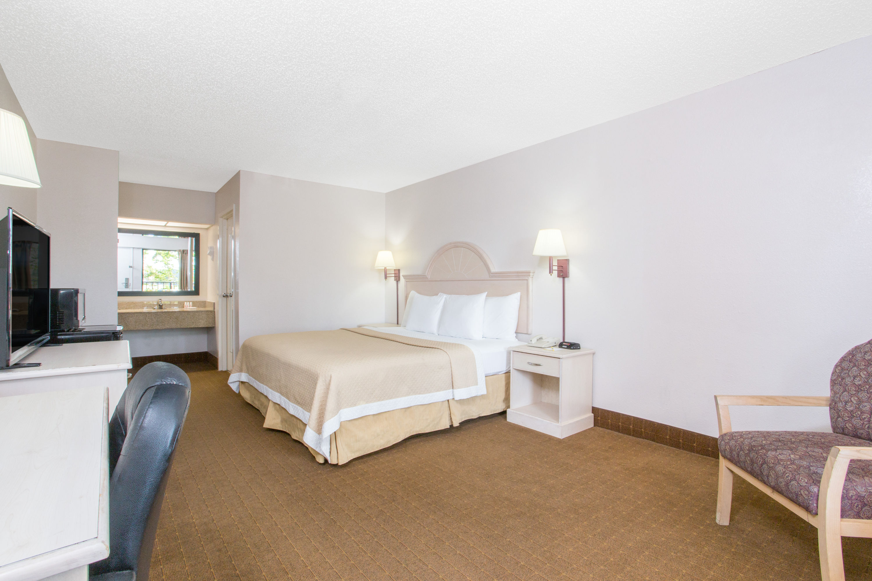 Guest room at the Days Inn & Suites by Wyndham Navarre - near Beaches/Hurlburt in Navarre, Florida