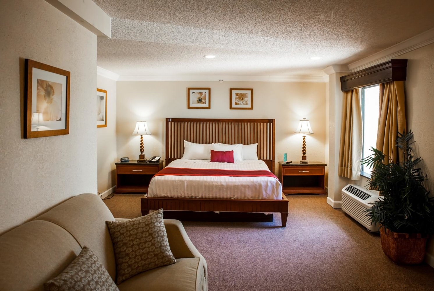 King bed guest room at the Days Inn & Suites by Wyndham Lake Okeechobee in Okeechobee, Florida