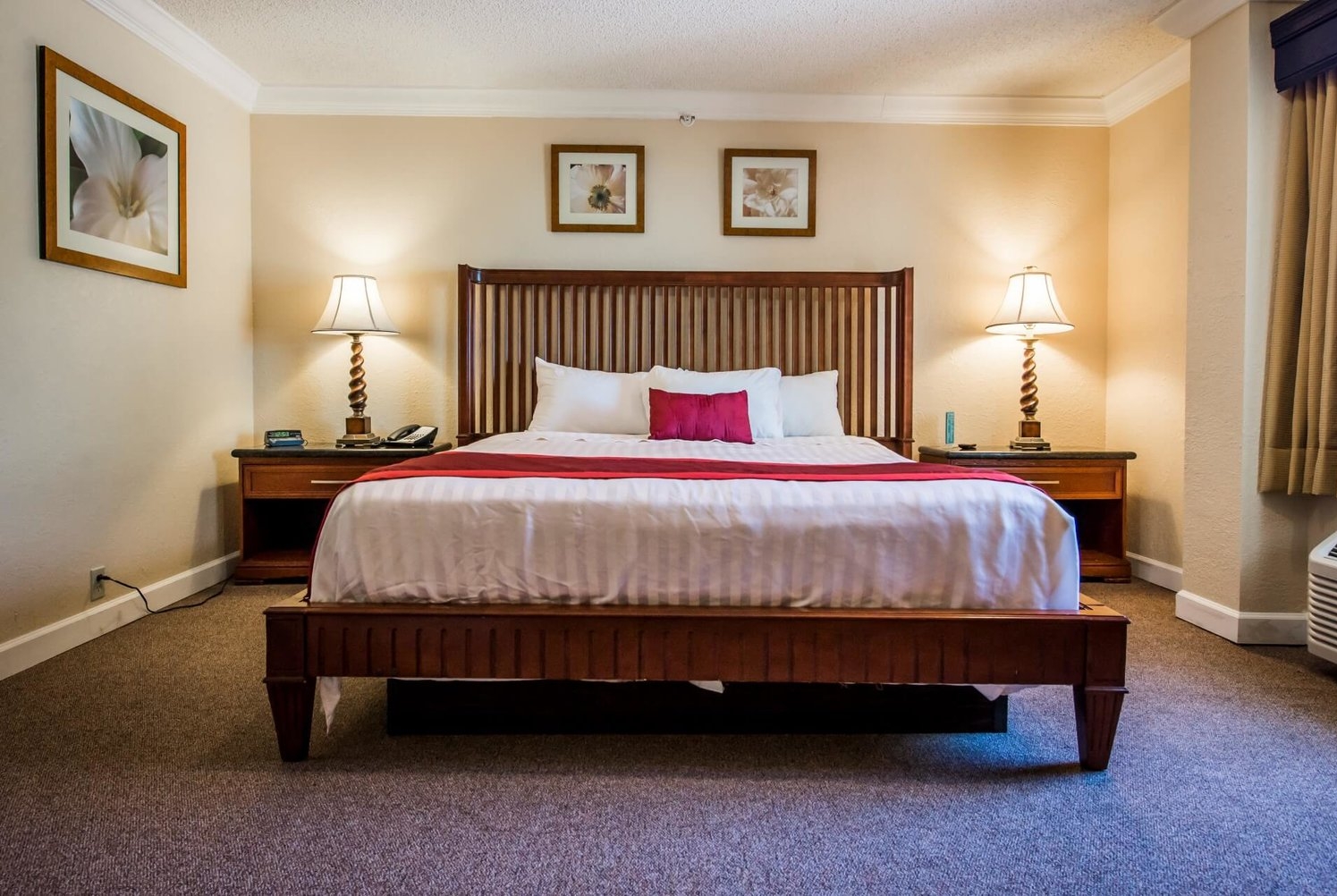 King bed guest room at the Days Inn & Suites by Wyndham Lake Okeechobee in Okeechobee, Florida