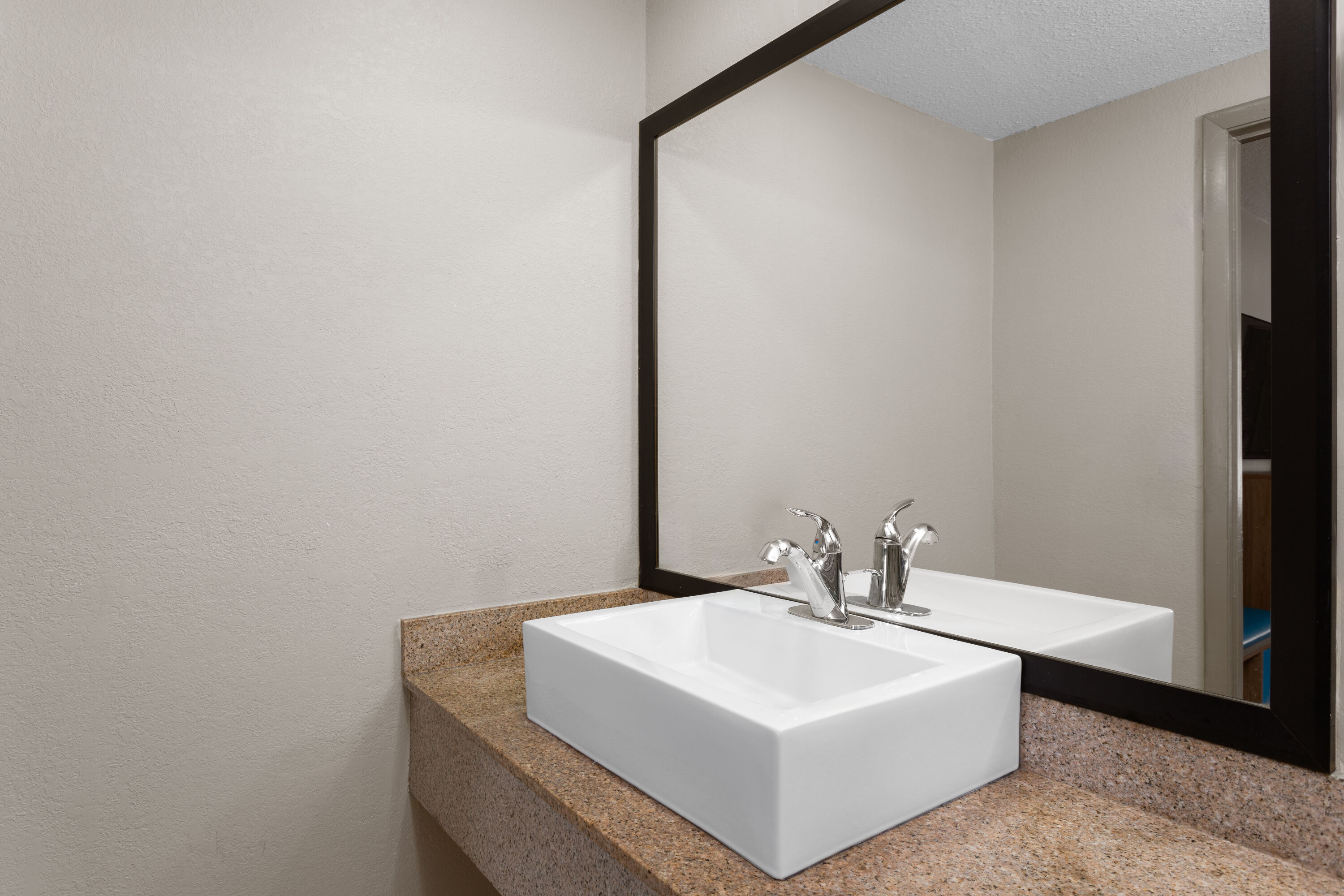 Guest room bath at the Days Inn by Wyndham St. Petersburg Central in Saint Petersburg, Florida