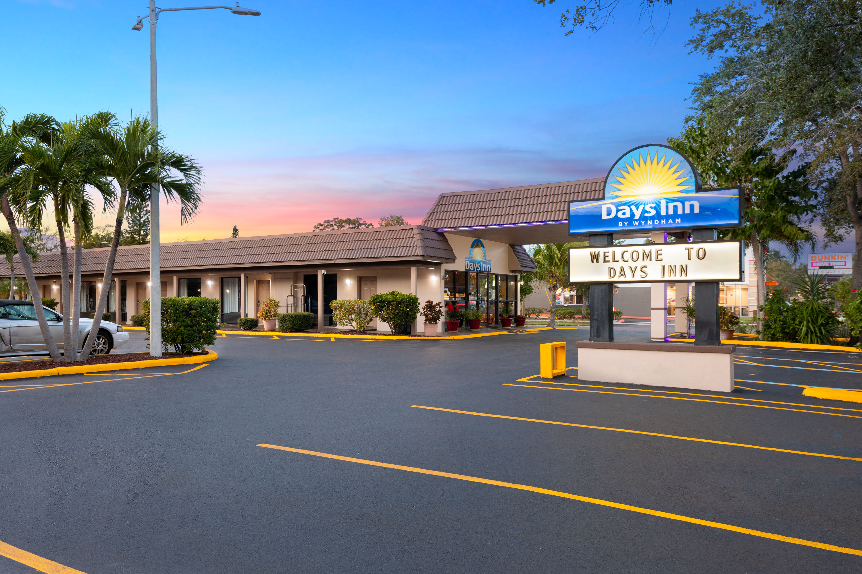 Exterior Dusk Image of Days Inn by Wyndham St. Petersburg Central hotel in Saint Petersburg, Florida
