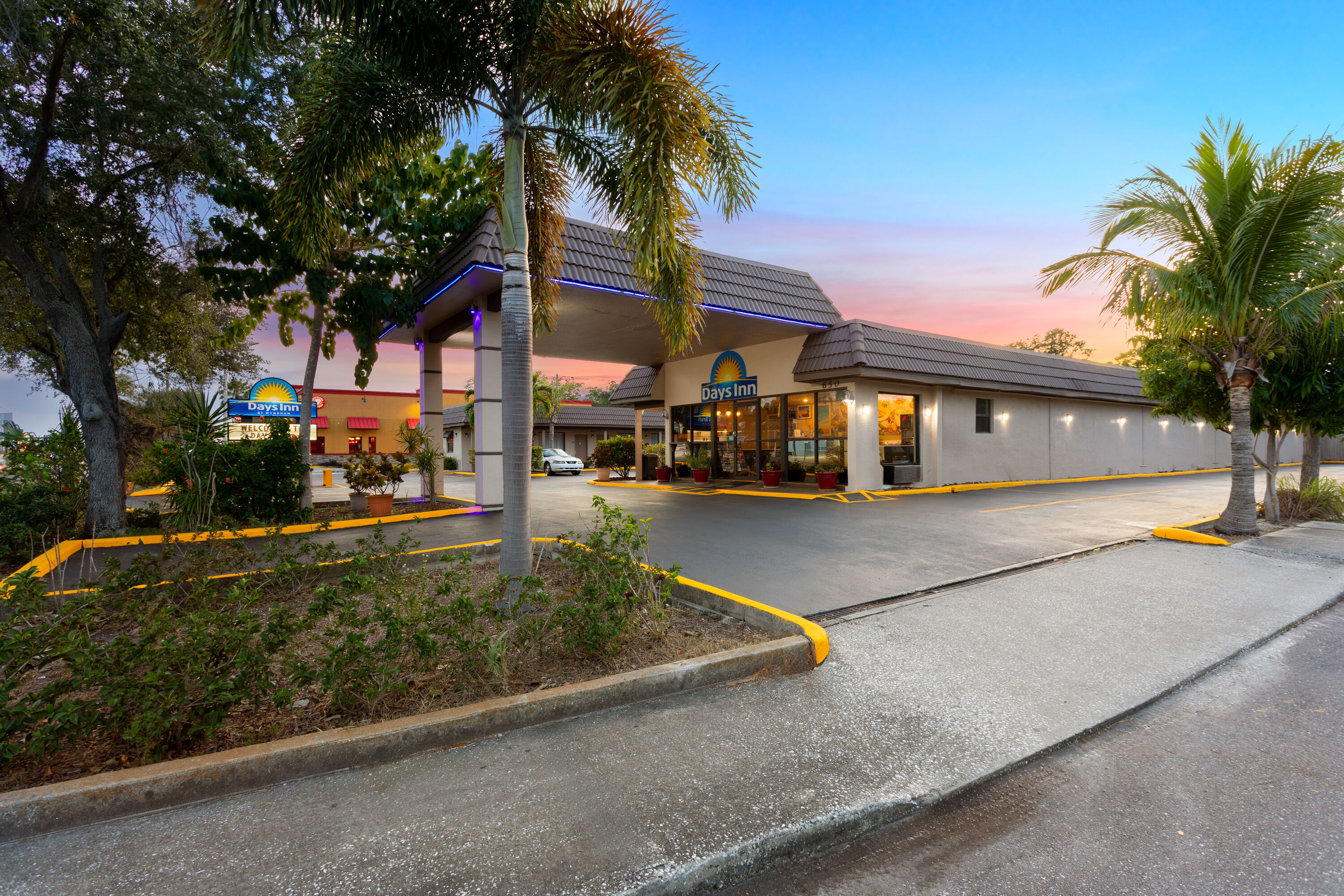 Exterior Dusk Image of Days Inn by Wyndham St. Petersburg Central hotel in Saint Petersburg, Florida