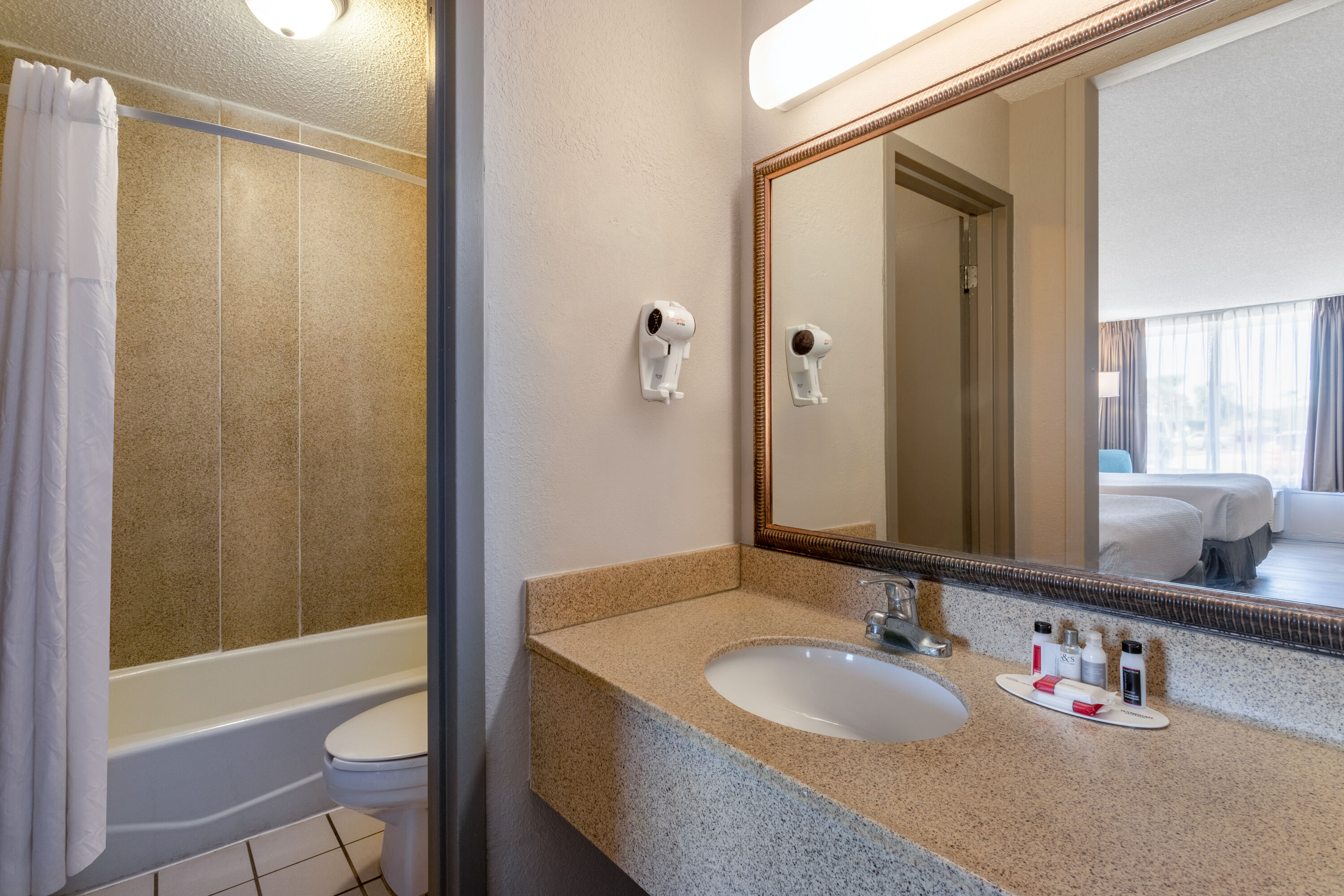 Guest room bath at the Days Inn by Wyndham Titusville Kennedy Space Center in Titusville, Florida