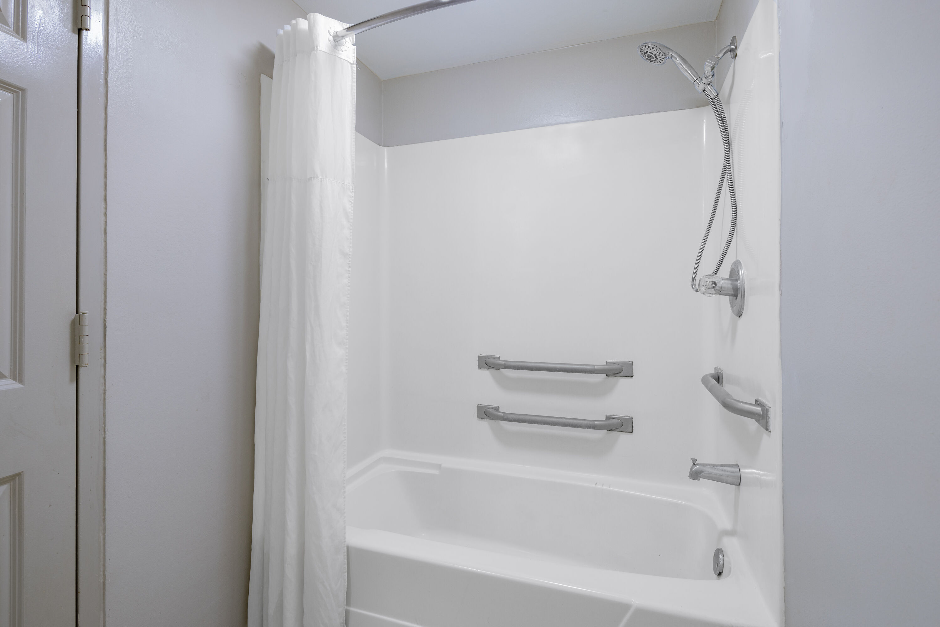 Guest room bath at the Days Inn & Suites by Wyndham Savannah Midtown in Savannah, Georgia