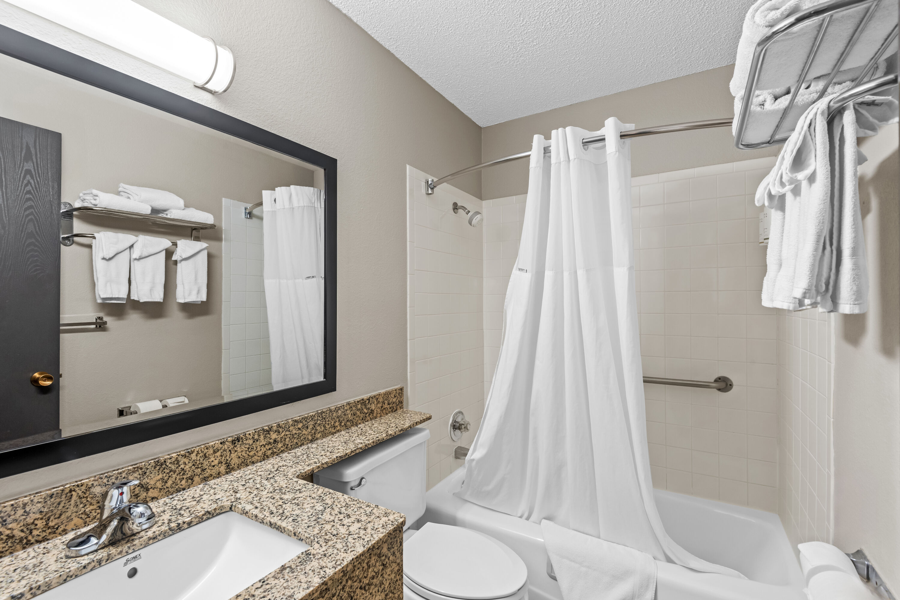 Guest room bath at the Days Inn & Suites by Wyndham Des Moines Airport in Des Moines, Iowa