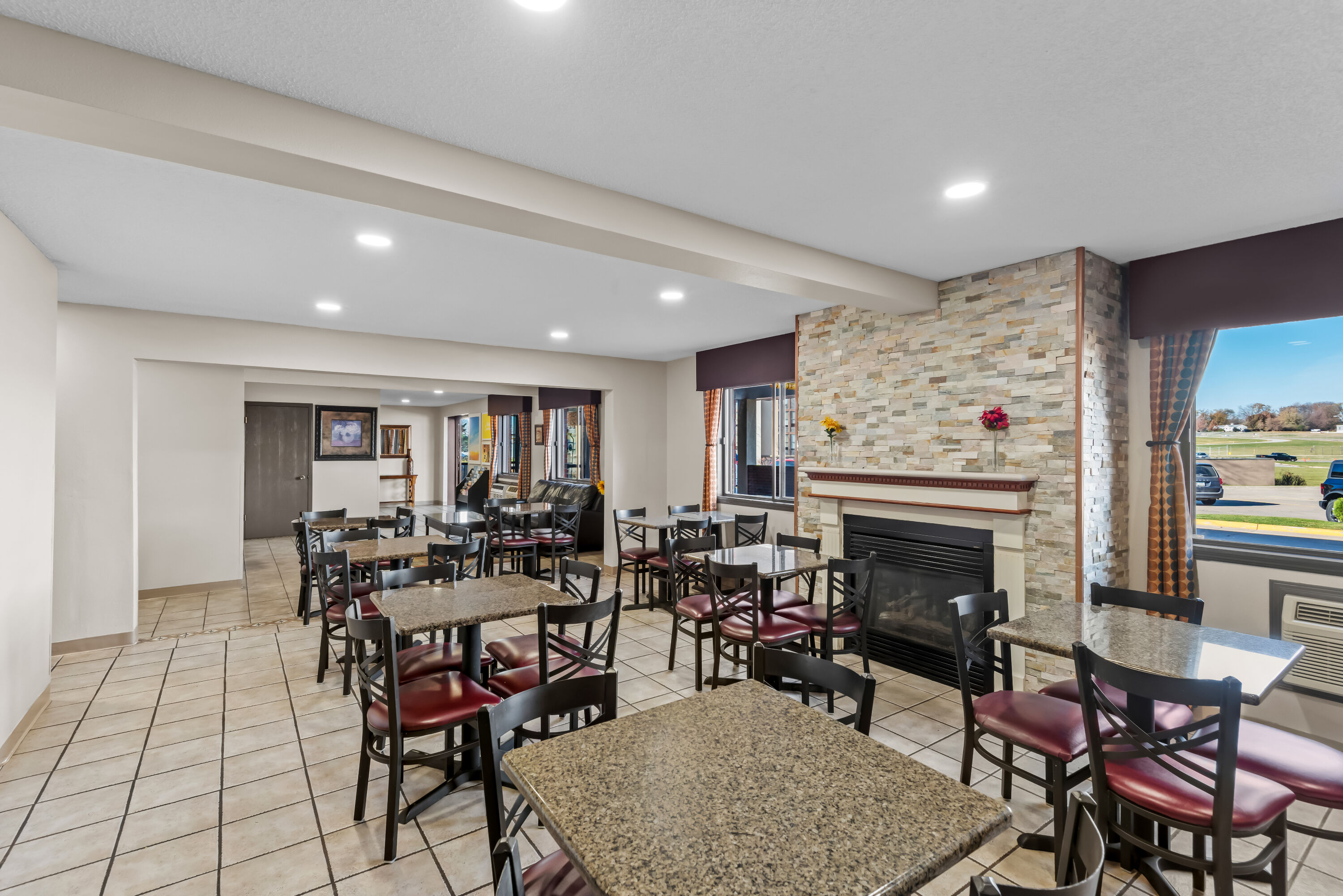 Days Inn & Suites by Wyndham Des Moines Airport restaurant breakfast area with seating in Des Moines, Iowa