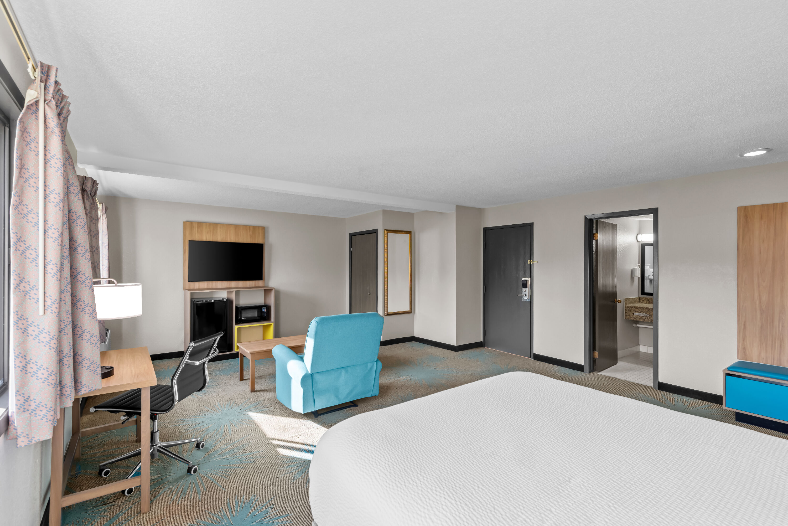 Queen bed guest room at the Days Inn & Suites by Wyndham Des Moines Airport in Des Moines, Iowa