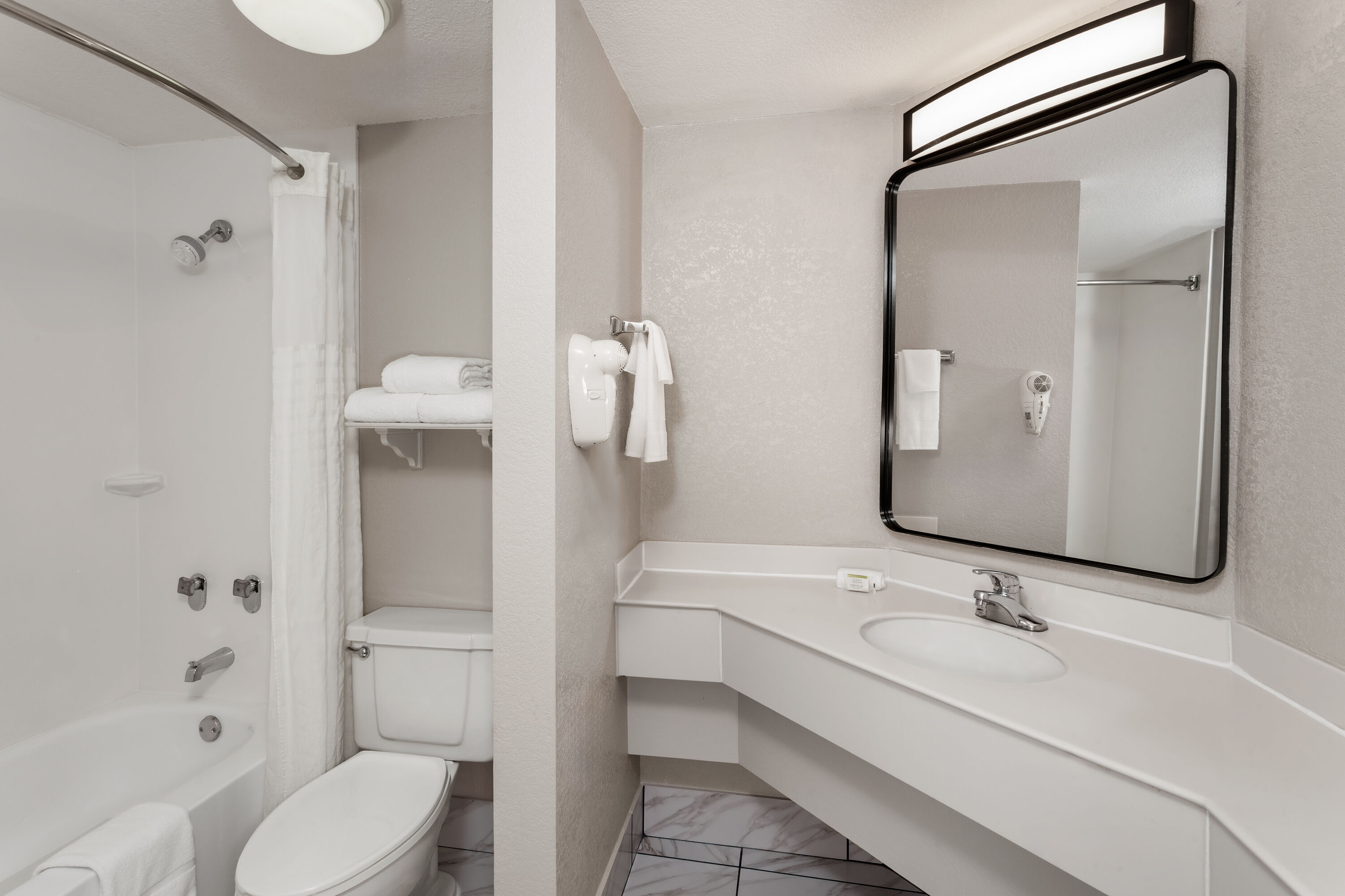 Guest room bath at the Days Inn & Suites by Wyndham Arlington Heights in Arlington Heights, Illinois