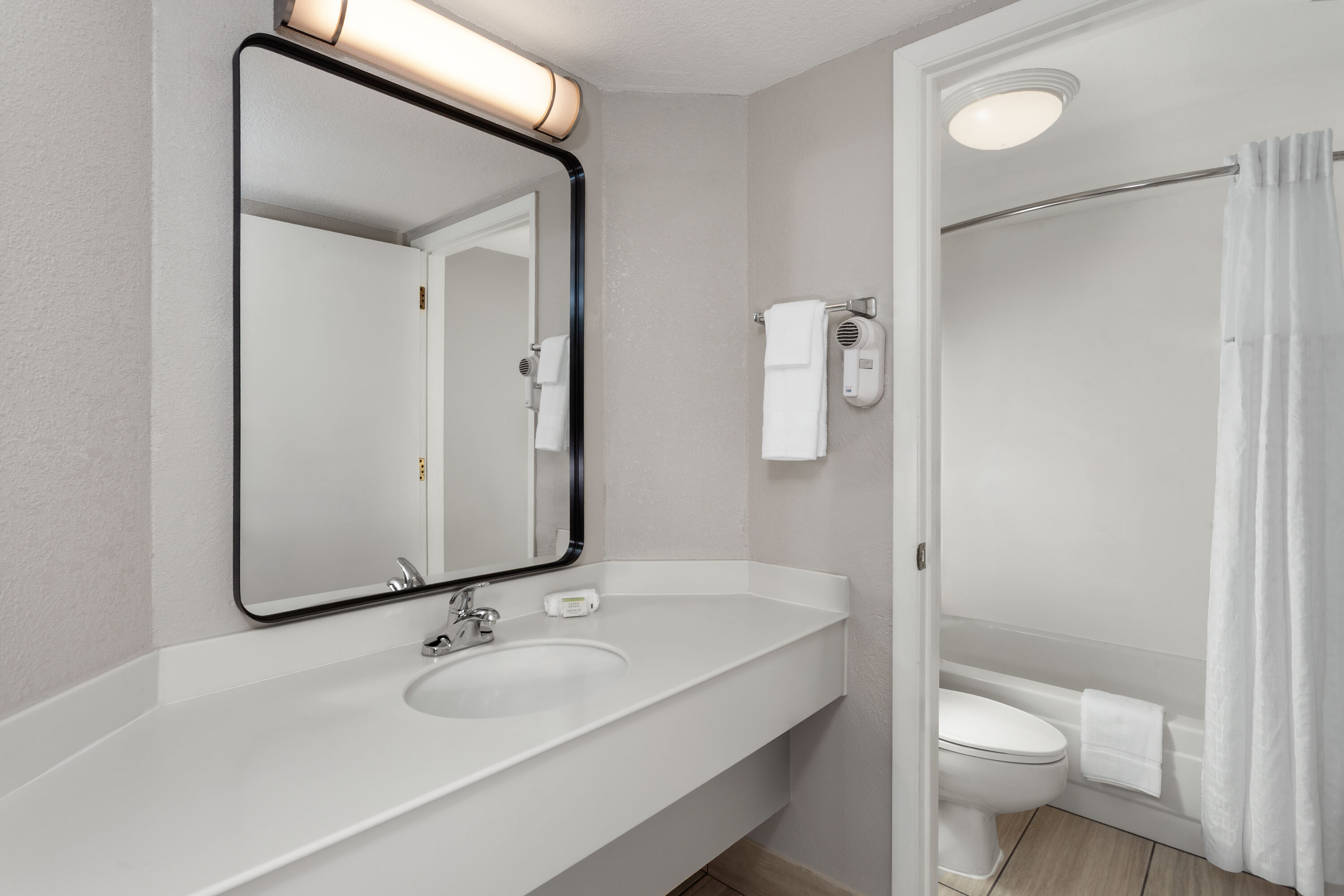 Guest room bath at the Days Inn & Suites by Wyndham Arlington Heights in Arlington Heights, Illinois