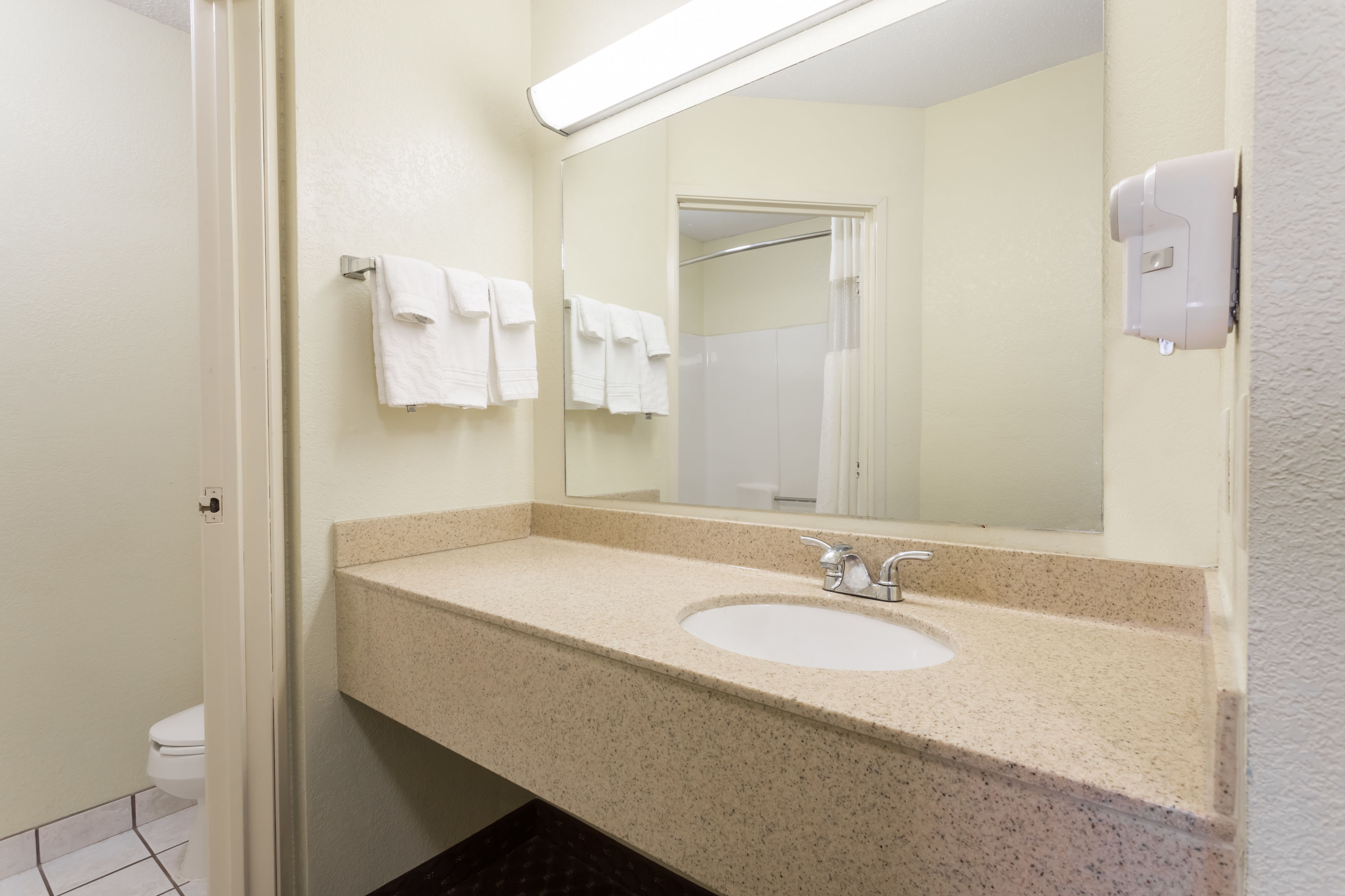 Guest room bath at the Days Inn & Suites by Wyndham Bloomington/Normal IL in Bloomington, Illinois
